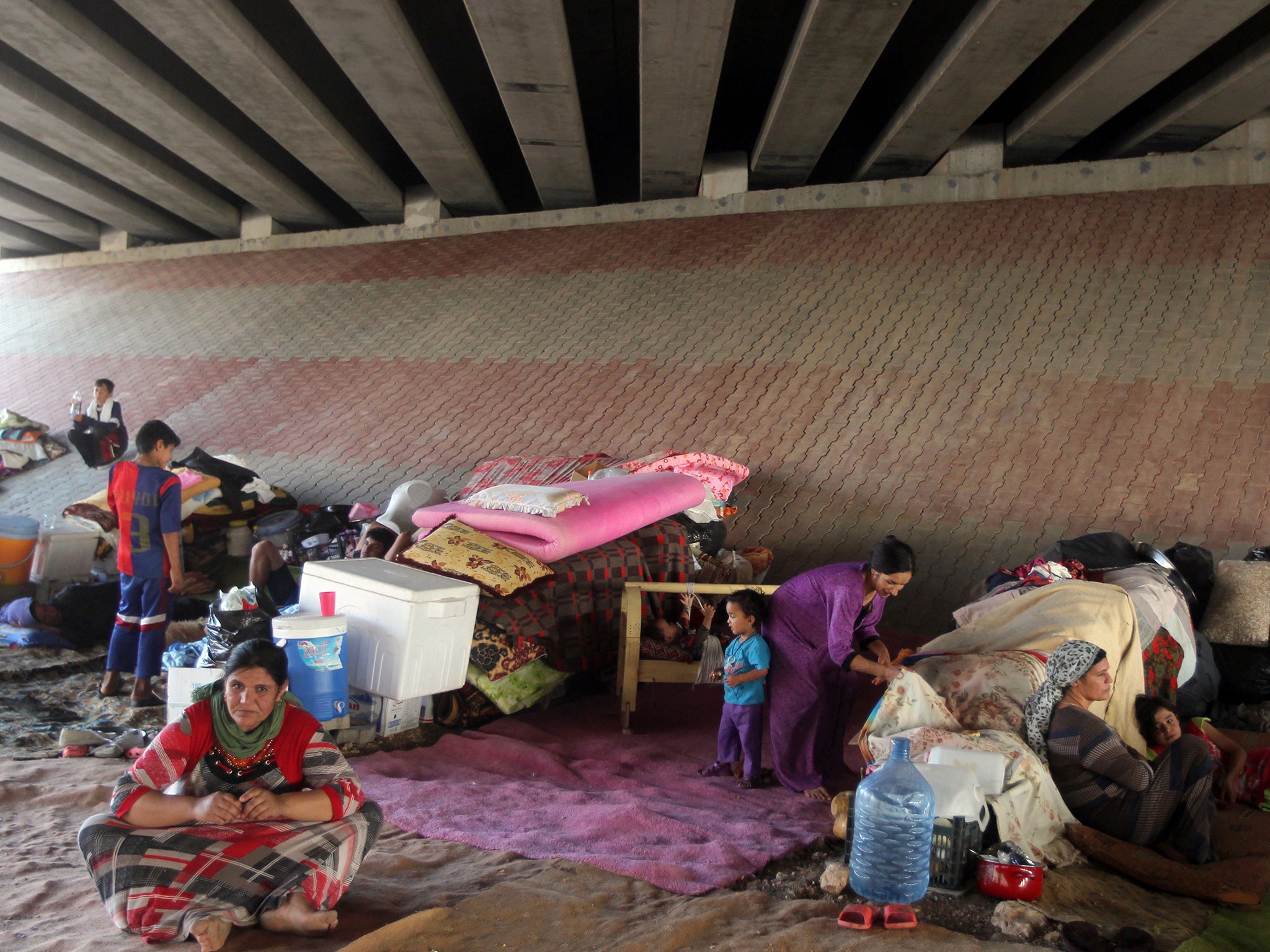 Displaced Iraqis shelter following the Isis attack on Sinjar (AFP)