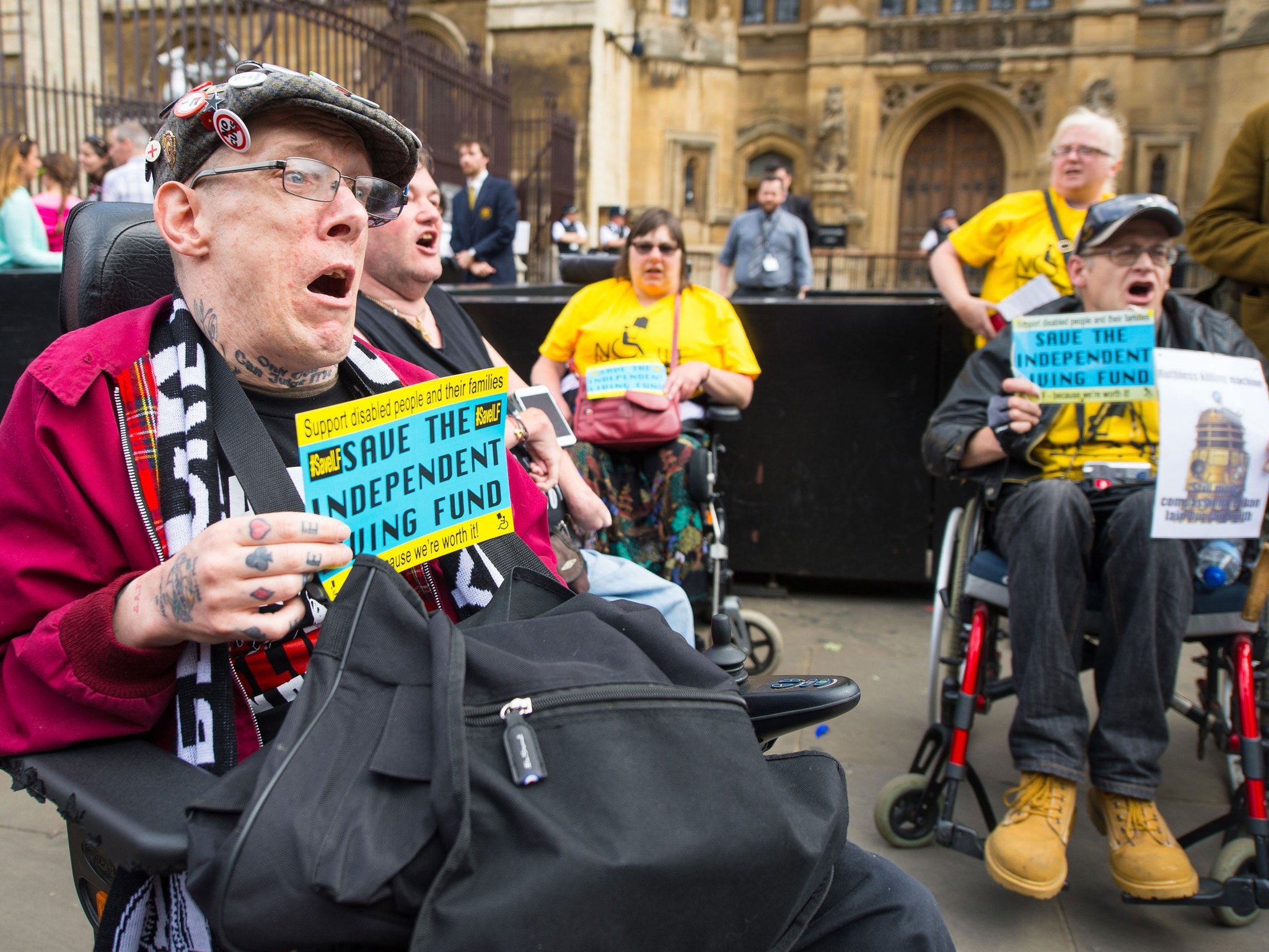 Disability rights campaigners protest outside the Houses of Parliament