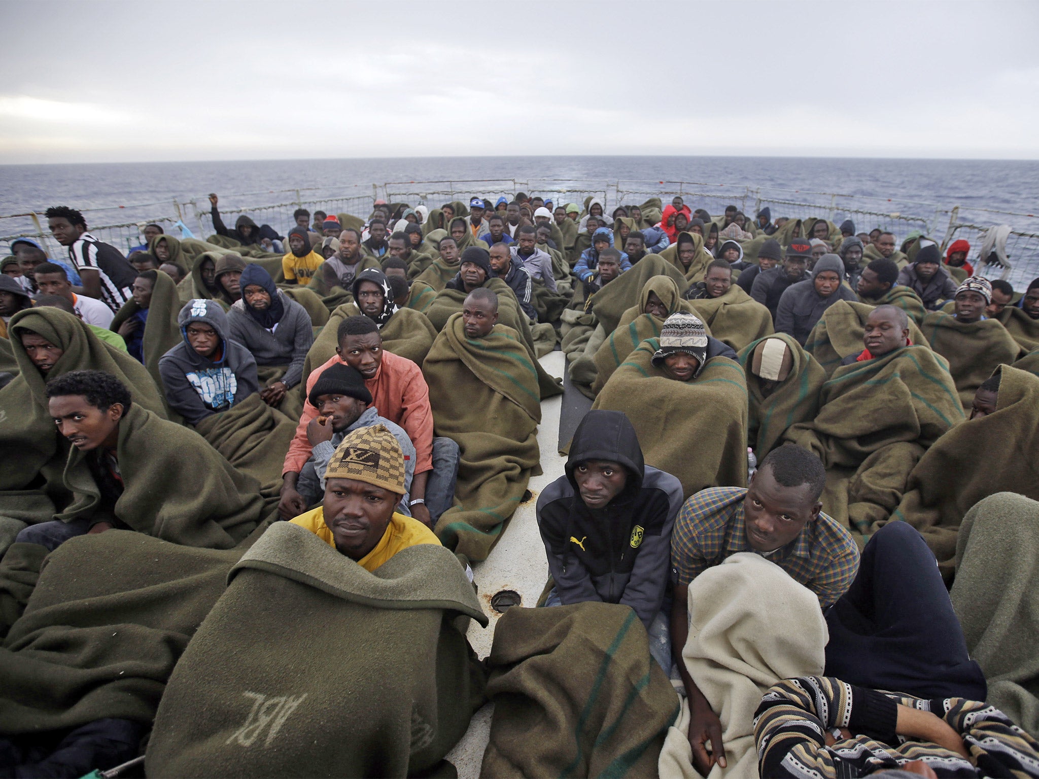 Migrants on the Belgian Navy vessel Godetia after they were saved during a search and rescue mission in the Mediterranean off the Libyan coast, June 2015