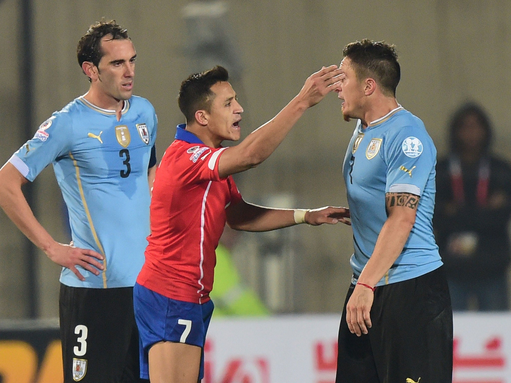 Alexis Sanchez gestures to Christian Rodriguez