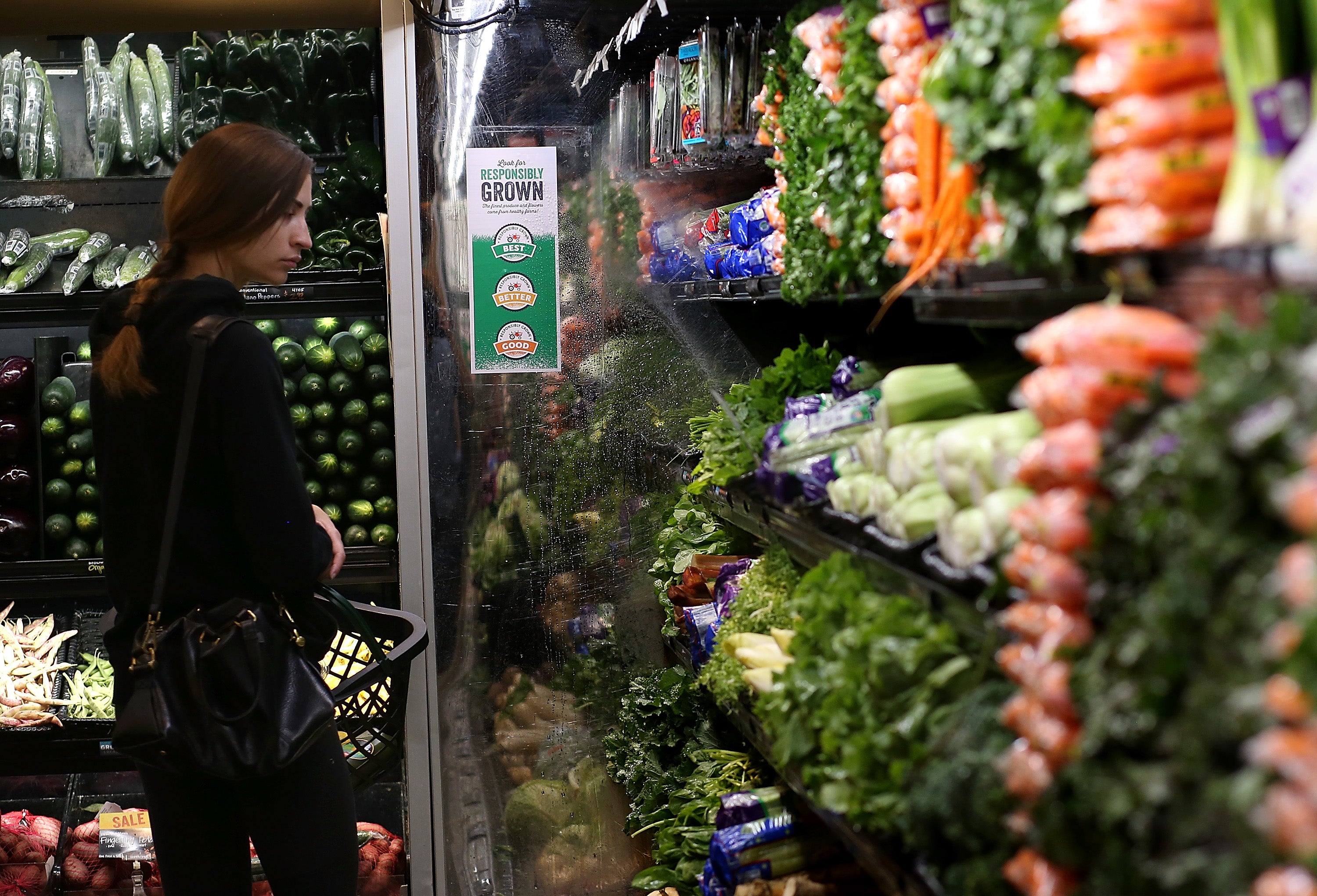 A customer shops for produce at a Whole Foods market in California.