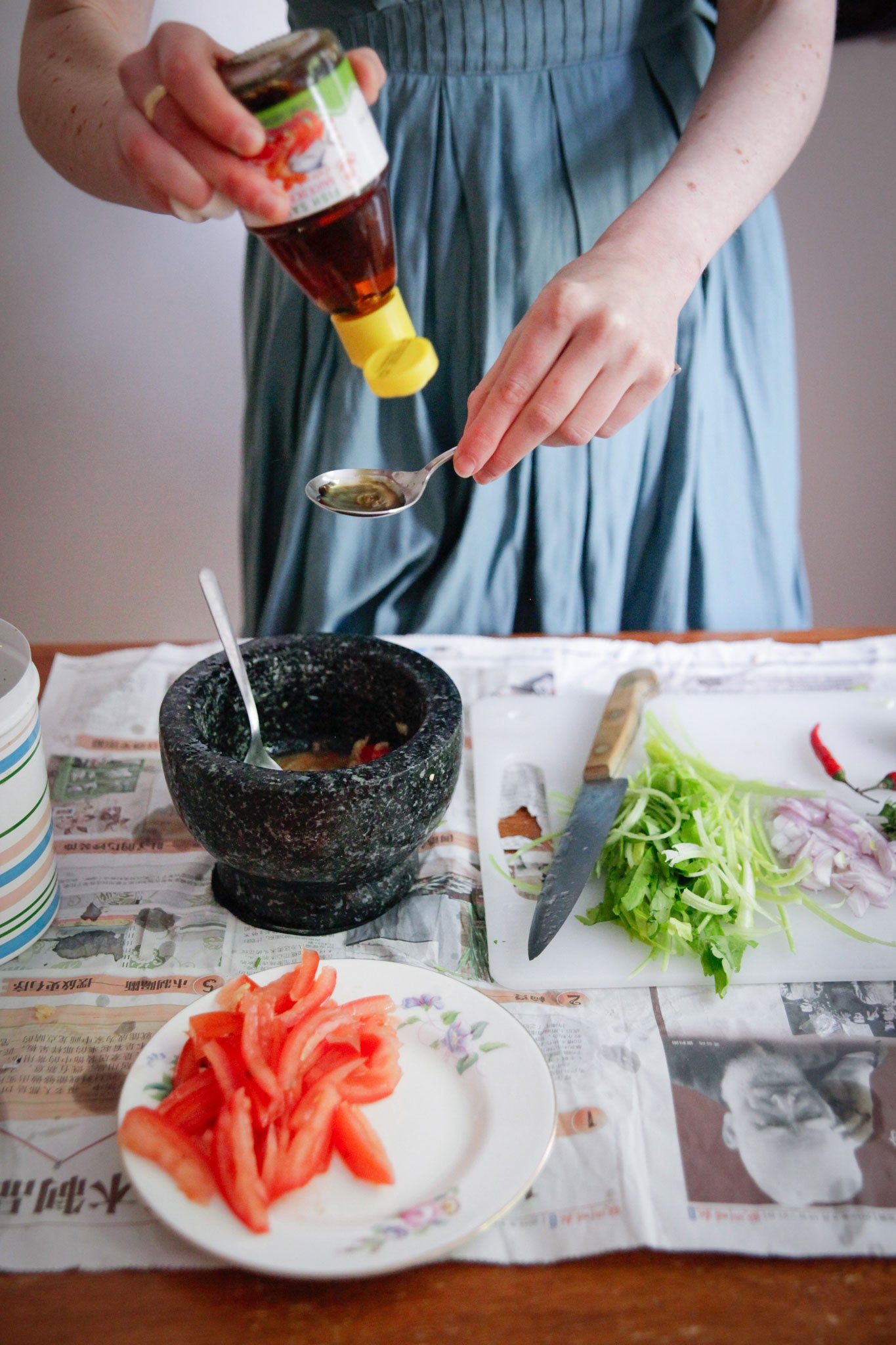 Holly adds fish sauce to her noodle-salad dressing