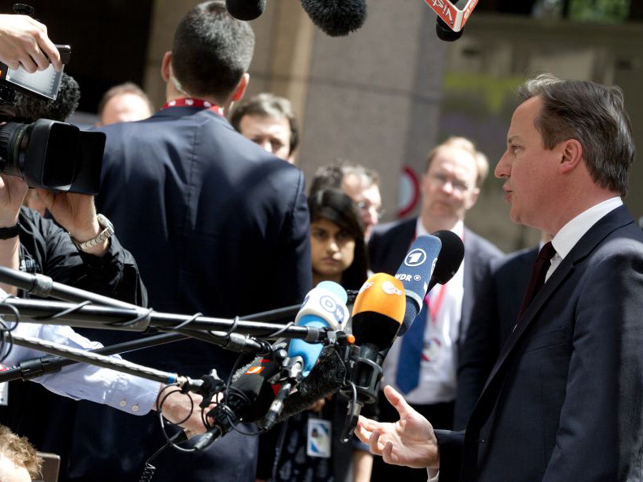 Prime Minister David Cameron speaks with the media at the EU summit in Brussels on Thursday