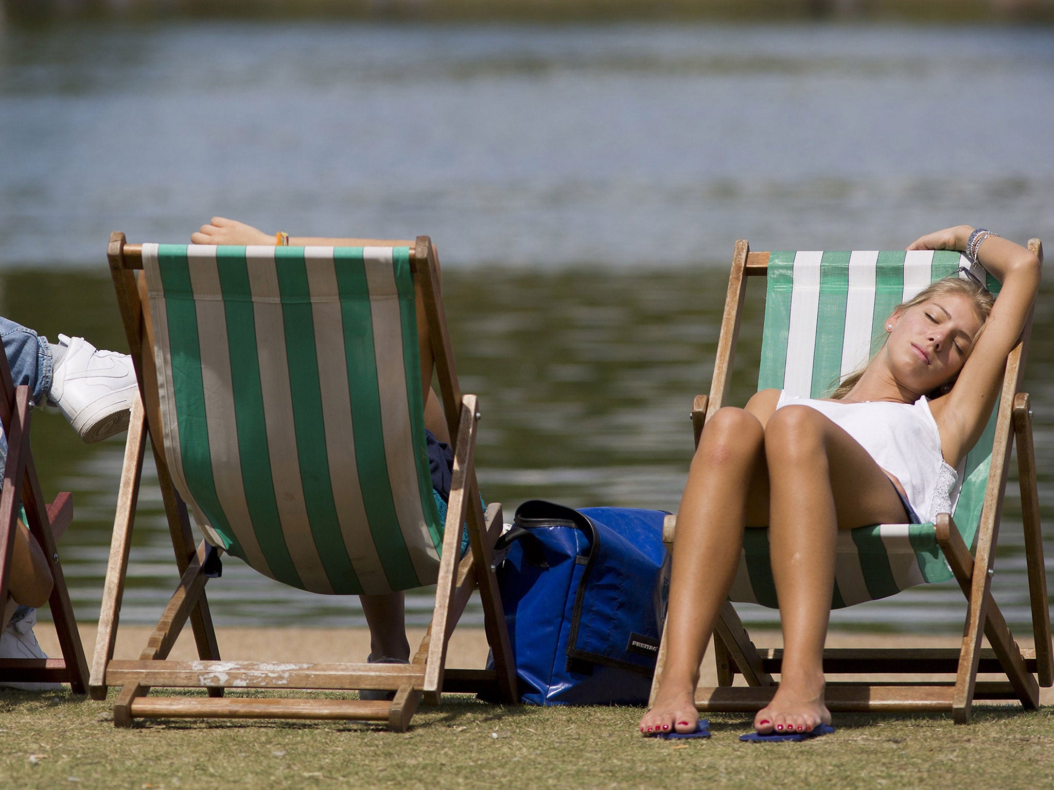 Sunbathers by the Serpentine in Hyde Park, central London (Getty)