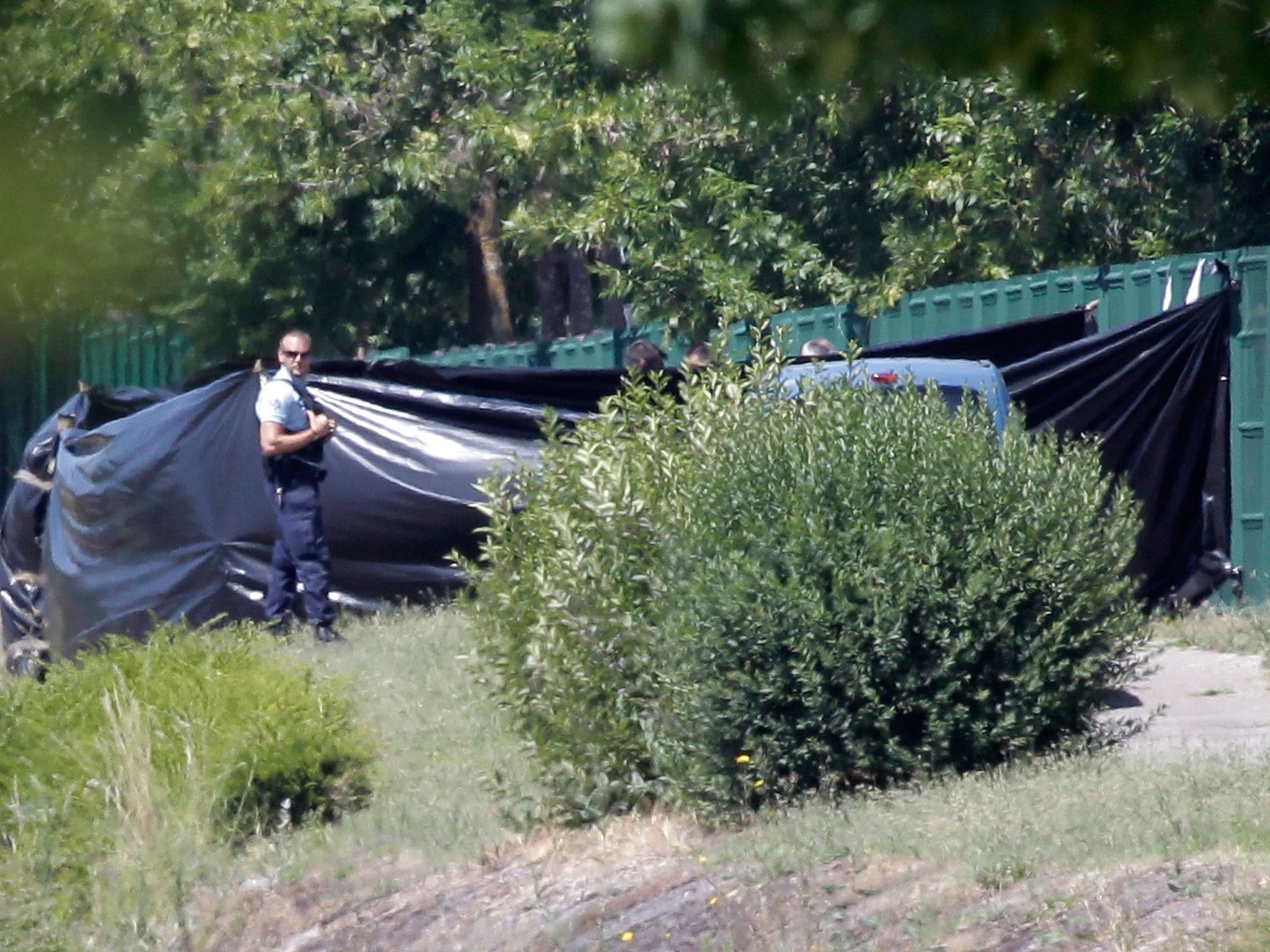 Emergency personnel work at the scene of a suspected Islamist attack, outside the Air Products factory in Saint-Quentin-Fallavier