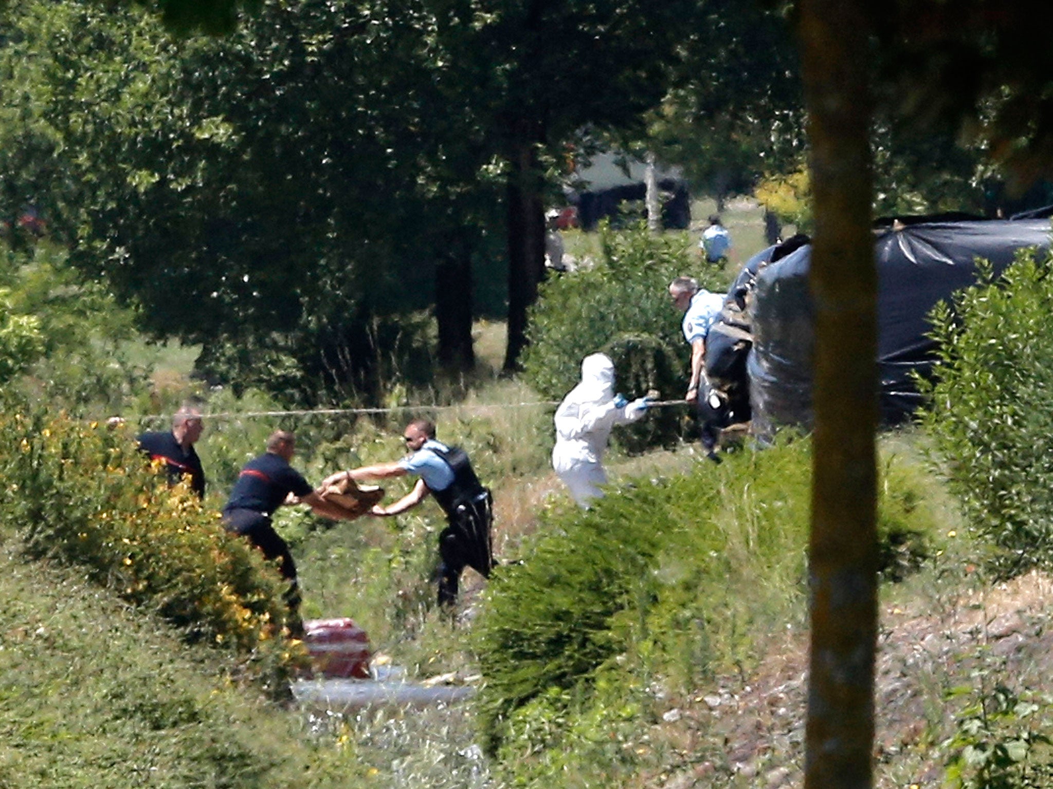 Investigating police officers work outside the plant where an attack took place, in Saint-Quentin-Fallavier, southeast of Lyon