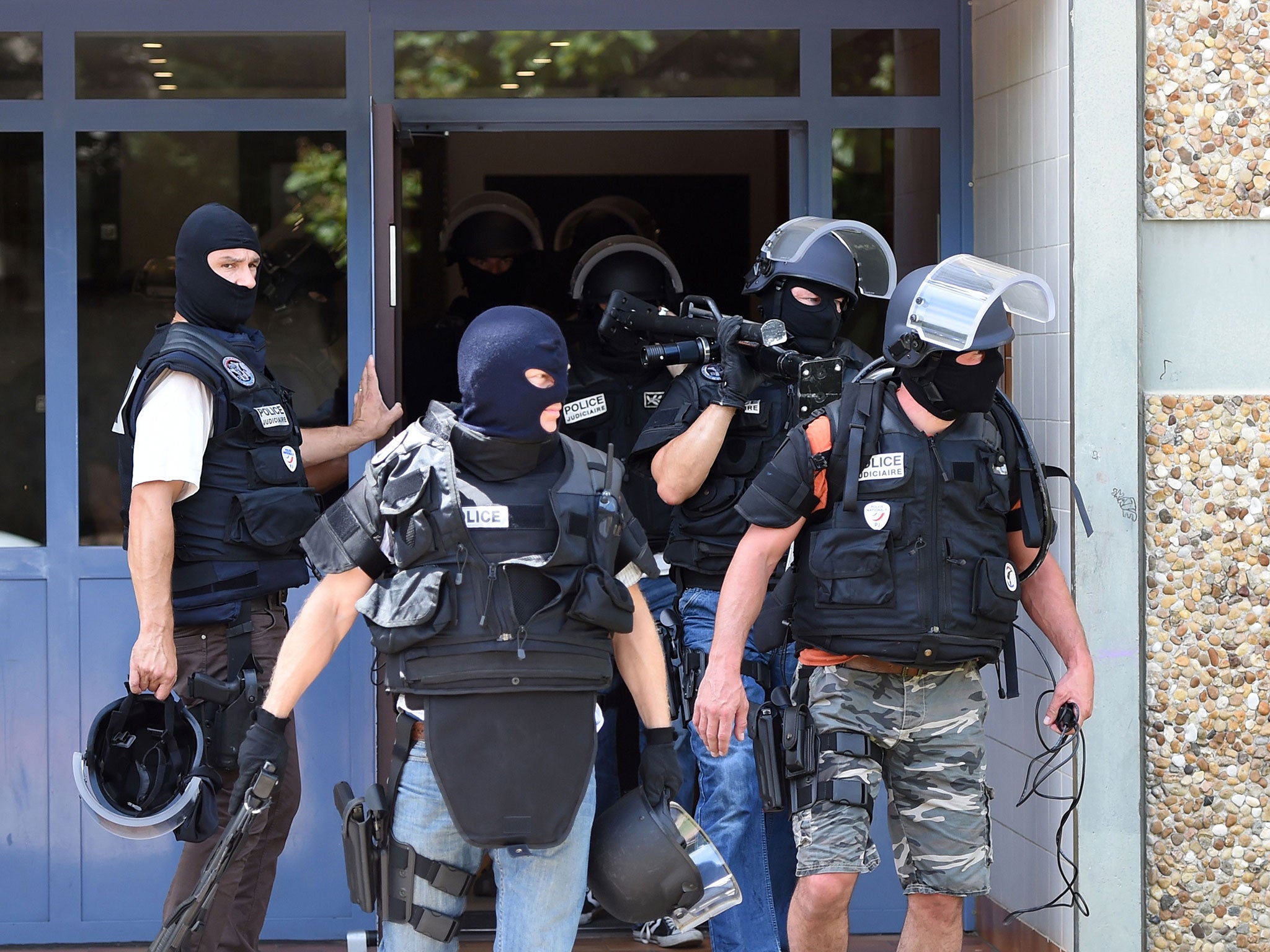 Special forces of France's Research and Intervention Brigades (BRI) leave the building housing the apartment of a man suspected of carrying out an attack in Saint-Priest near Lyon