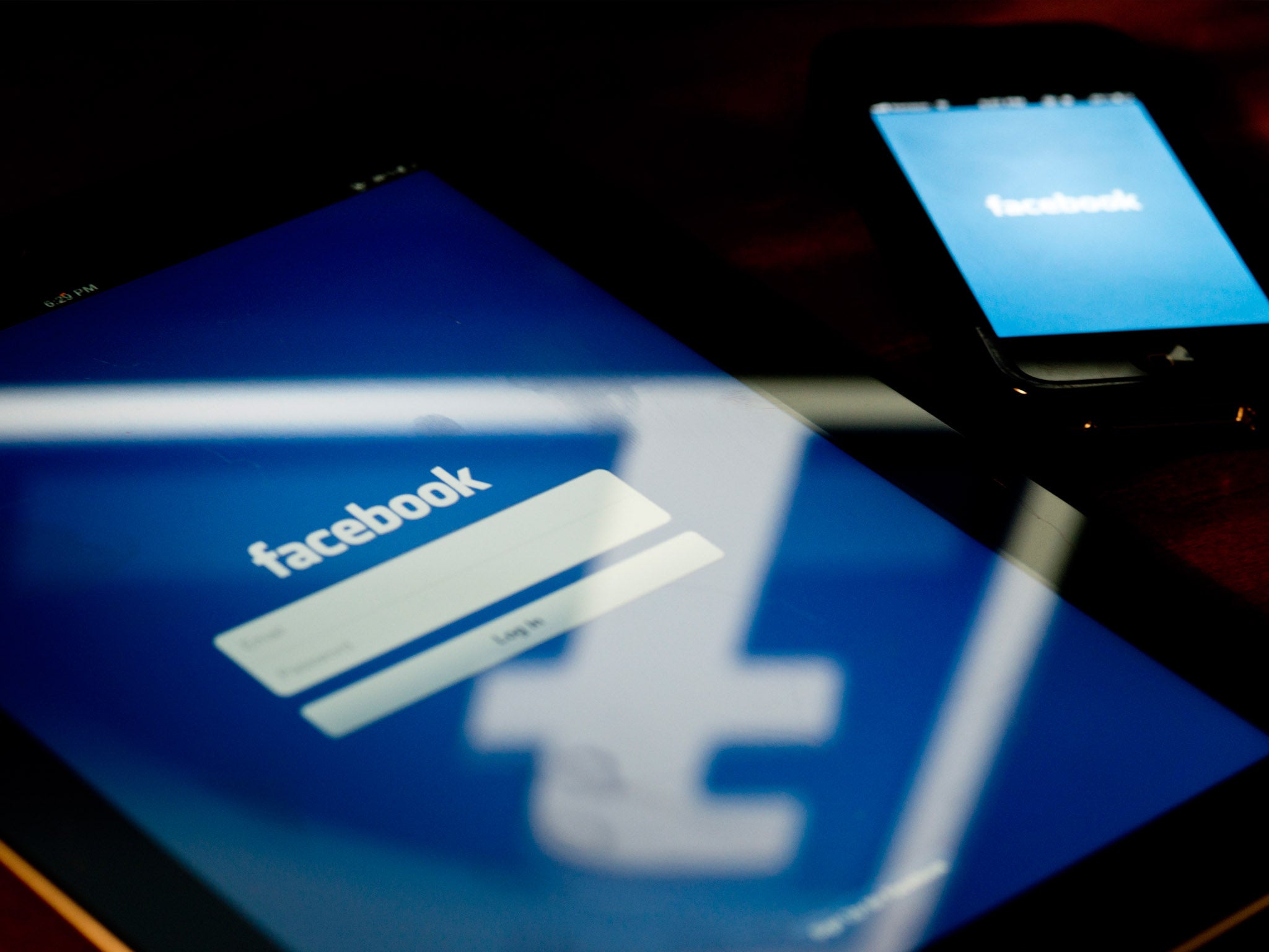 A view of an Apple iPad and iPhone displaying the Facebook app's splash screen 10 May 2012 in Washington, DC