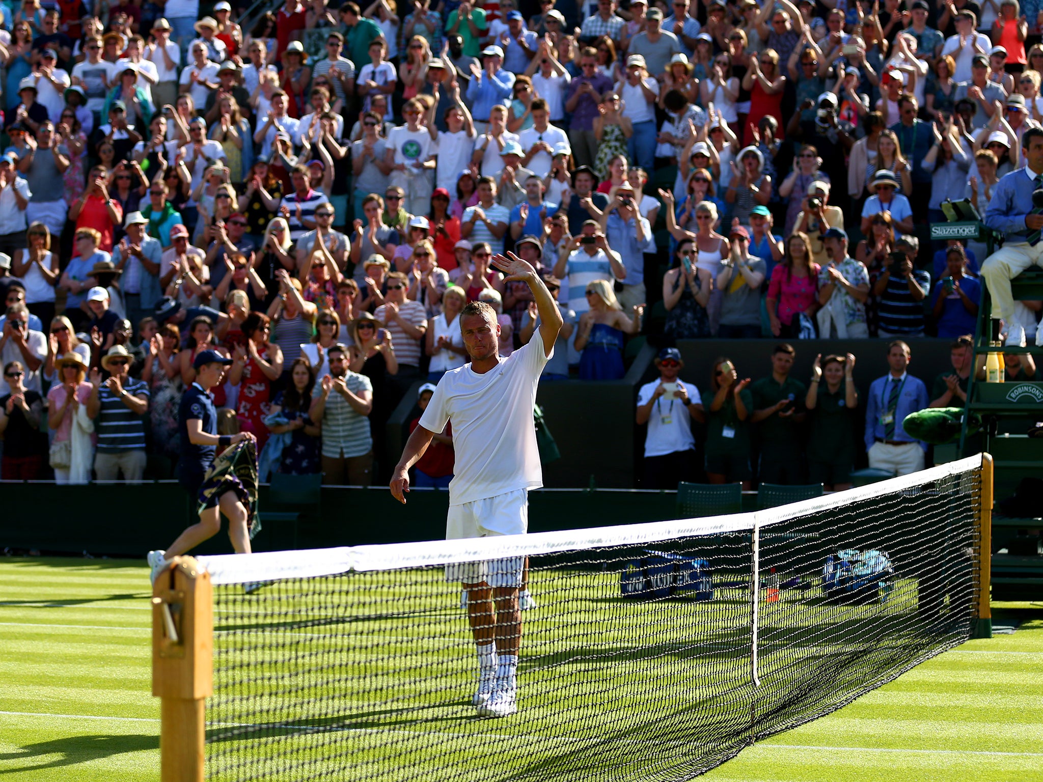 2002 champion Lleyton Hewitt is applauded off after making his final appearance at the tournament