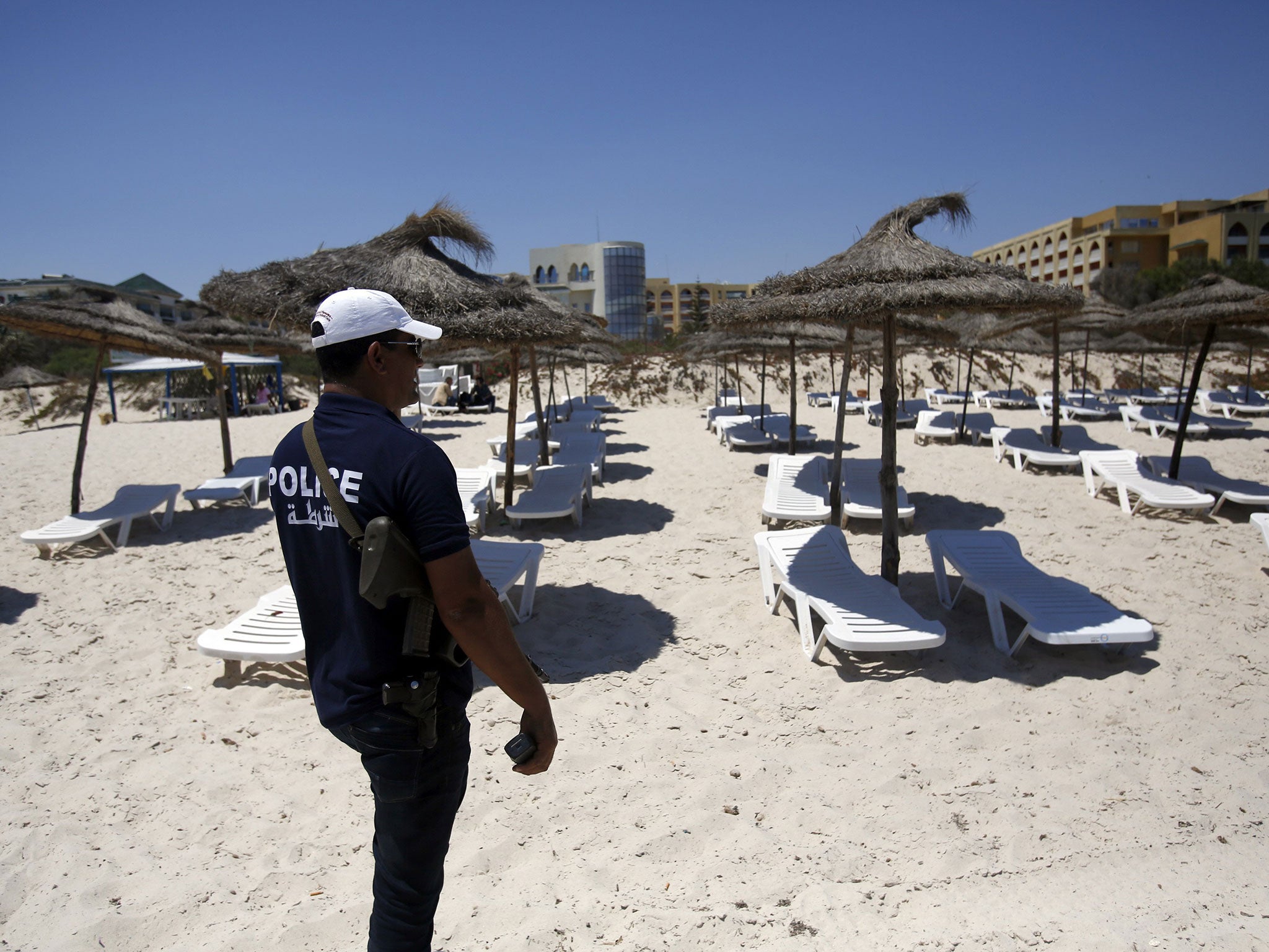 A Tunisian police officer guards a beach in front of the Imperial Marhaba Hotel in Sousse on Sunday