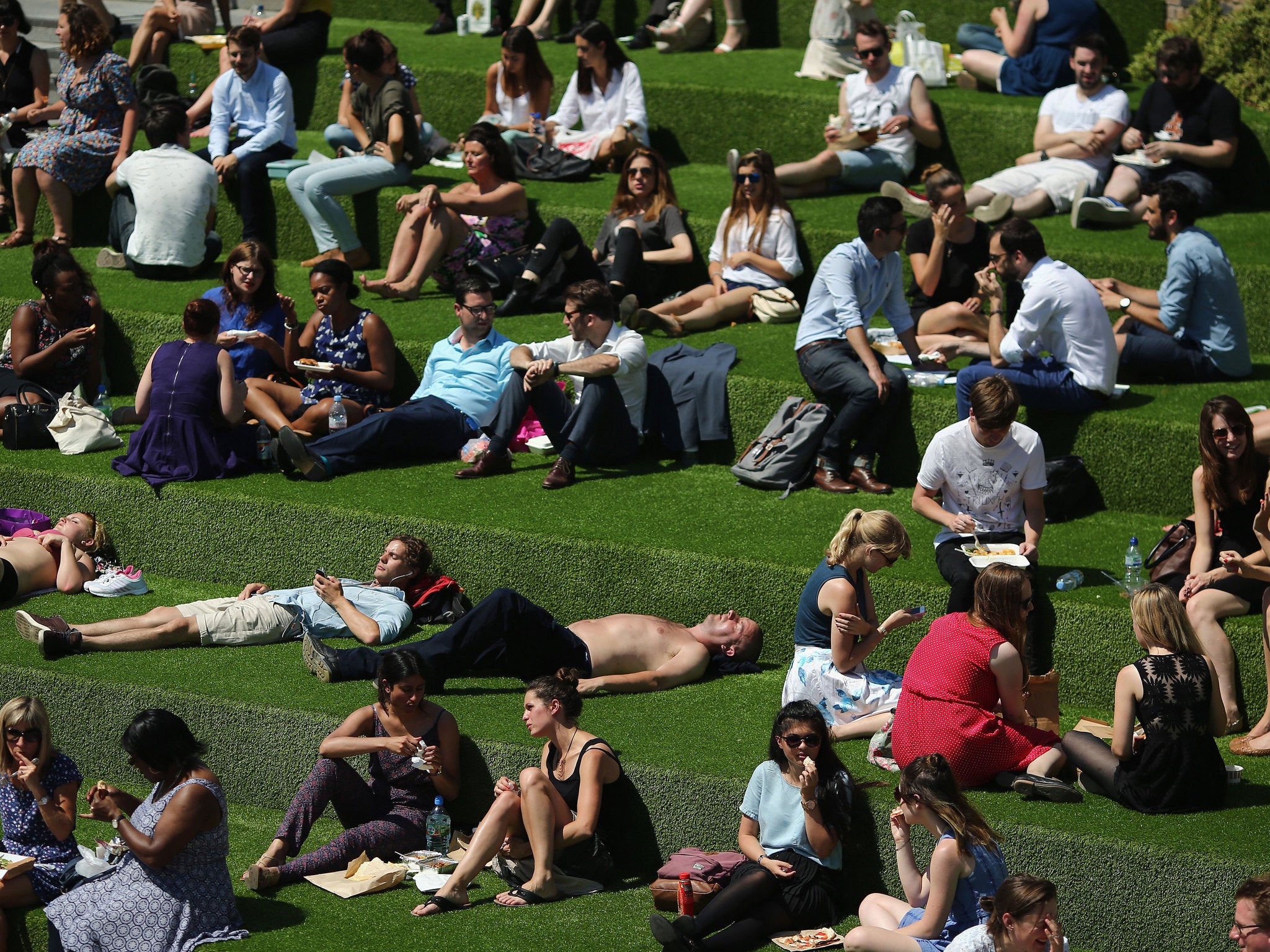 People relax near Regent's Canal in King's Cross, London