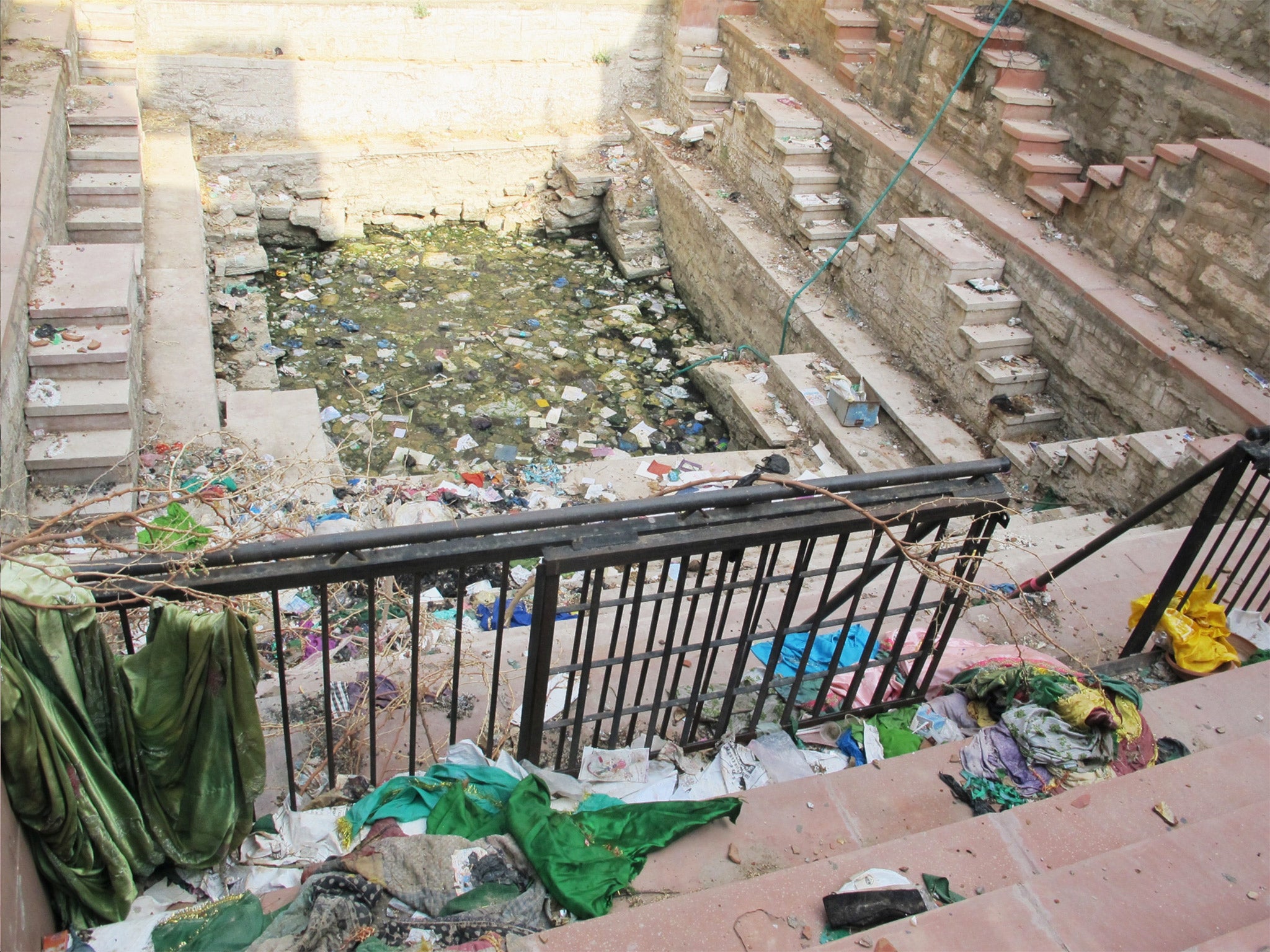 Only 130 of 125,000 homes in Ajmer, India, are connected to the sewage system. Dirty water flows in open drains in cramped neighborhoods, and stepwells, pictured, have become garbage dumps