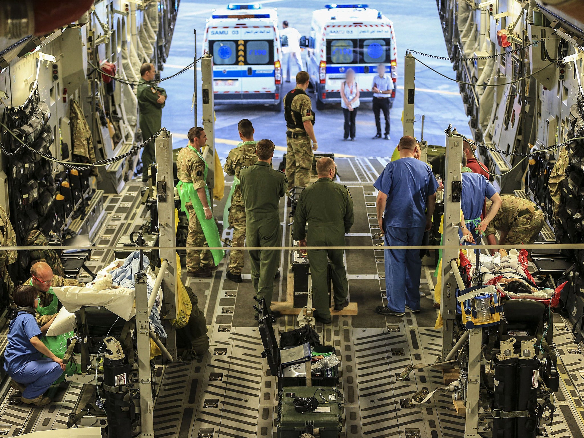 Military personnel attend to injured British tourists being flown back to the UK for treatment on Monday