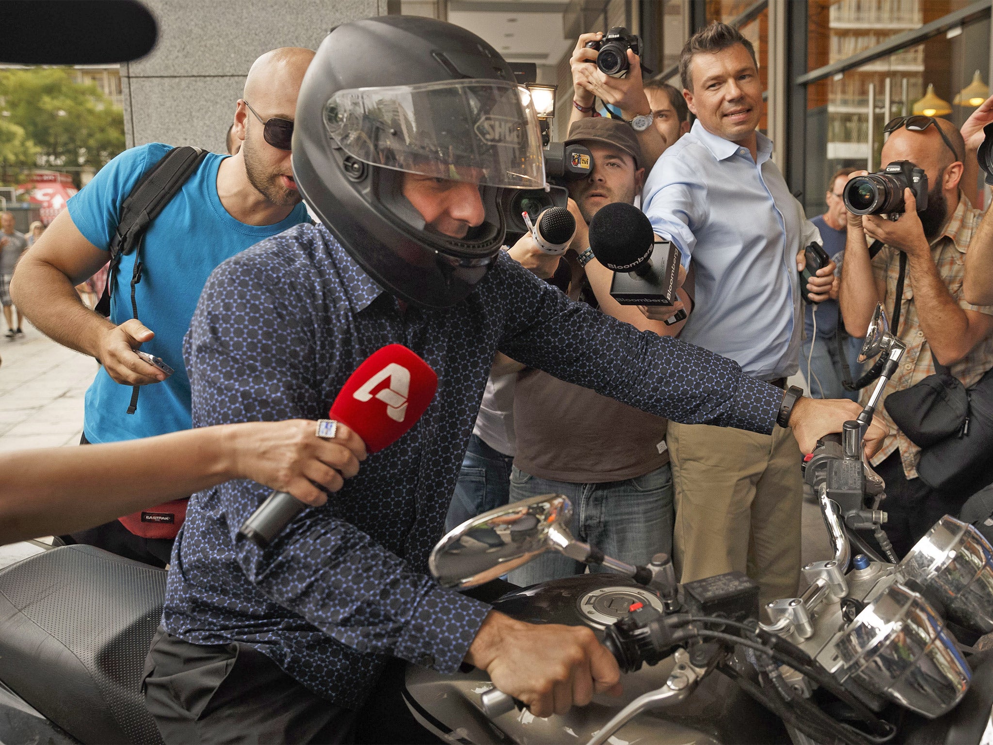 Greece’s Finance Minister Yanis Varoufakis is mobbed by the media as the country moved closer to the financial abyss