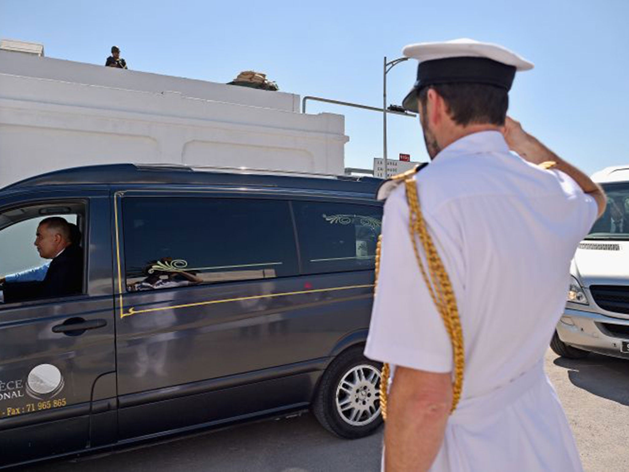 Ambulances carrying the victims of last Friday's terrorist attack arrive at Tunis Airport on their way back to the UK