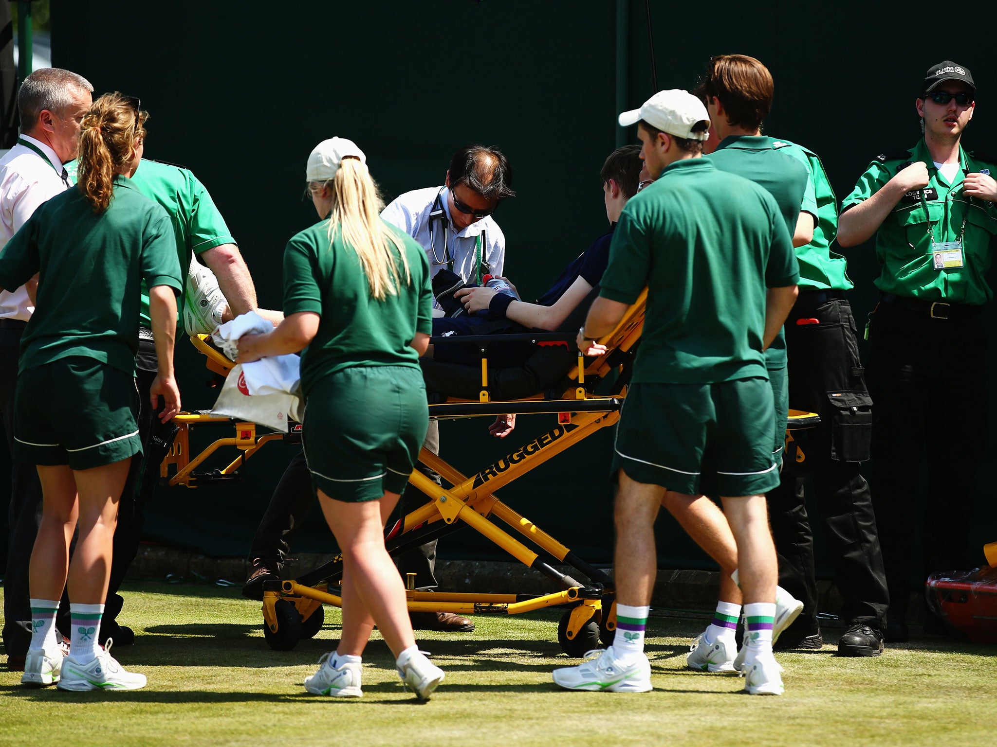 The boy is taken away from Court 17 on a stretcher