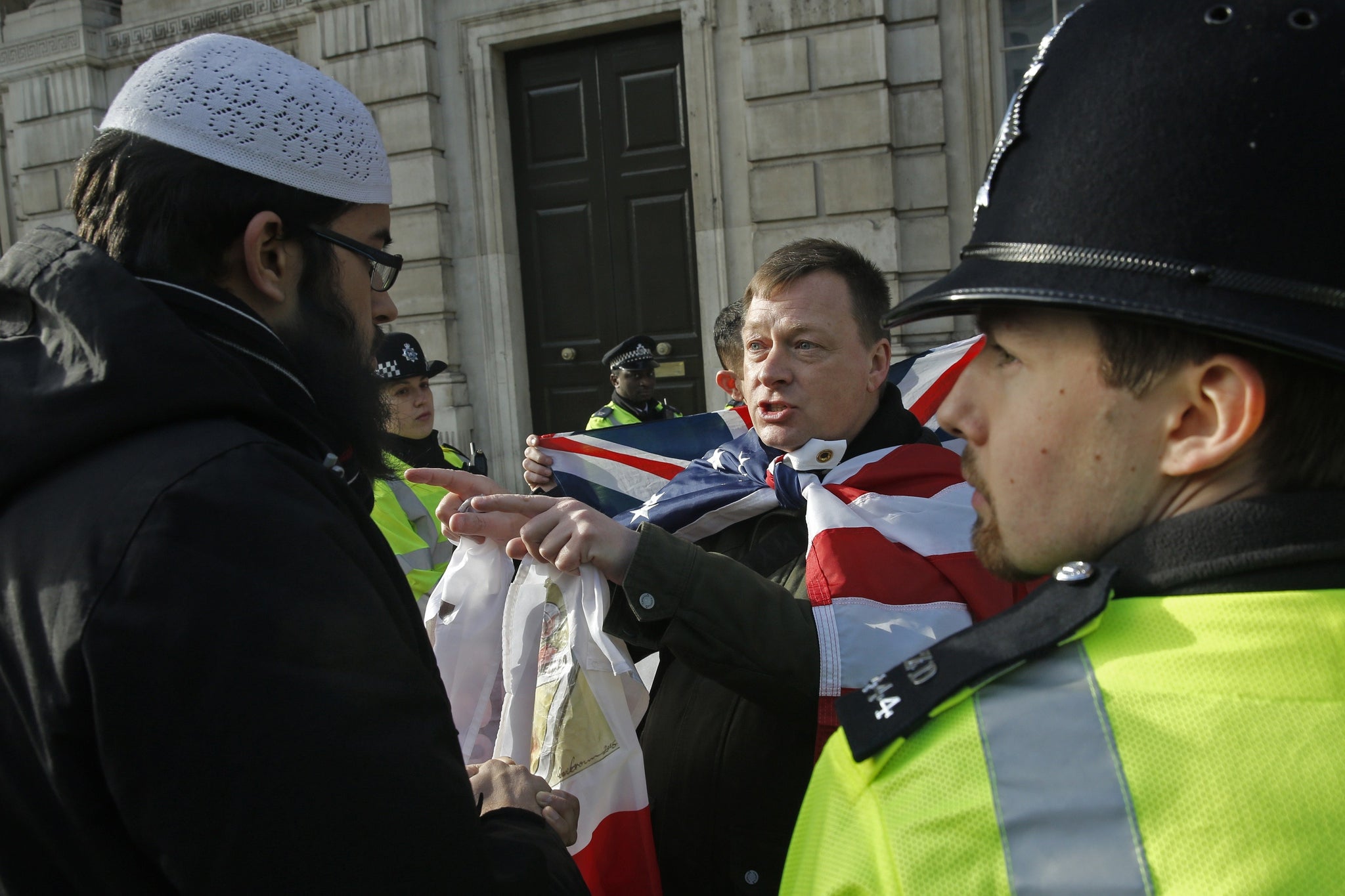 A Metropolitan Police officer stands by during a dispute between a member of Britain First and a Muslims demonstrator in February