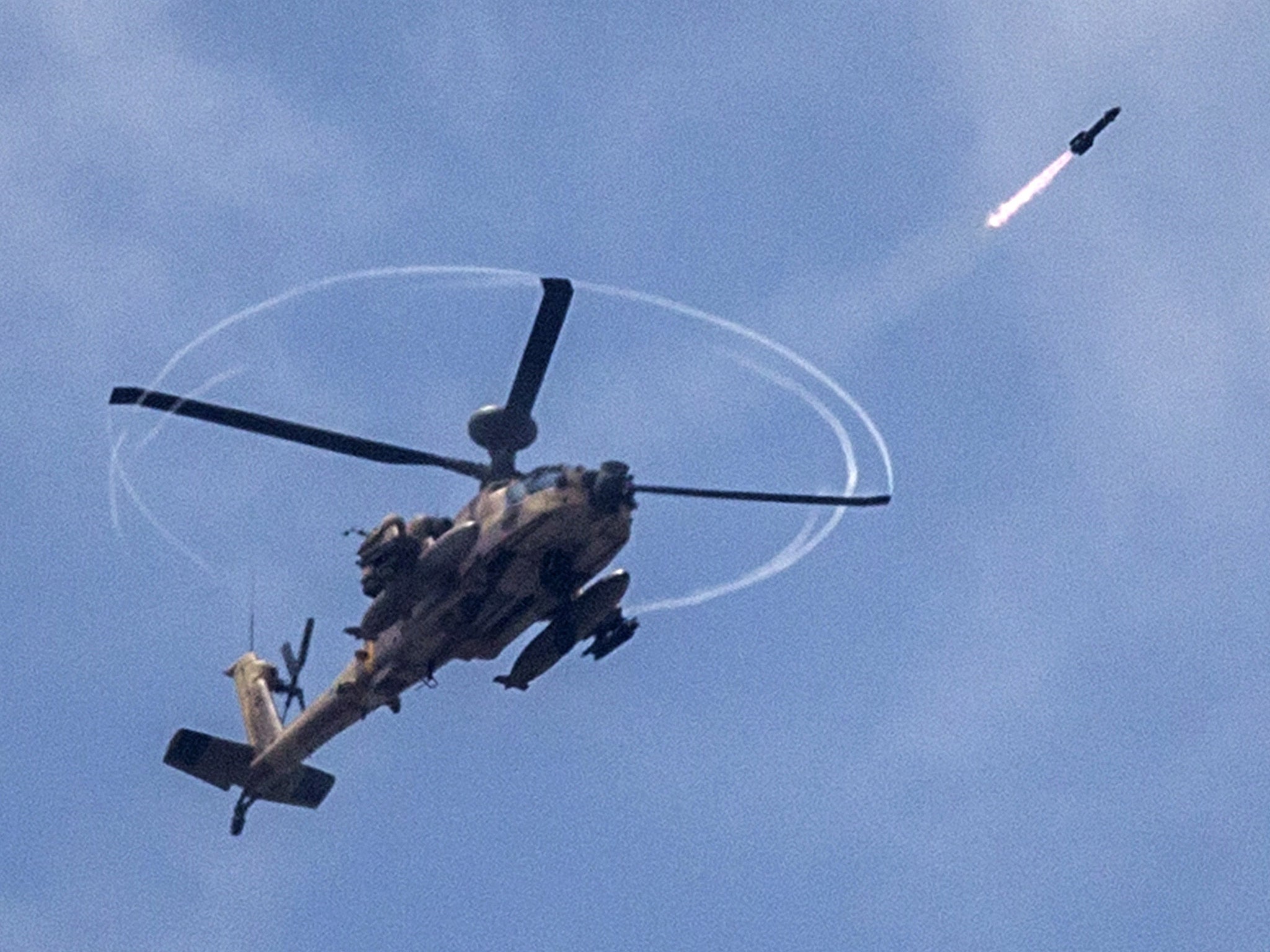 An Israeli helicopter fires a missile into Gaza last year (Getty)