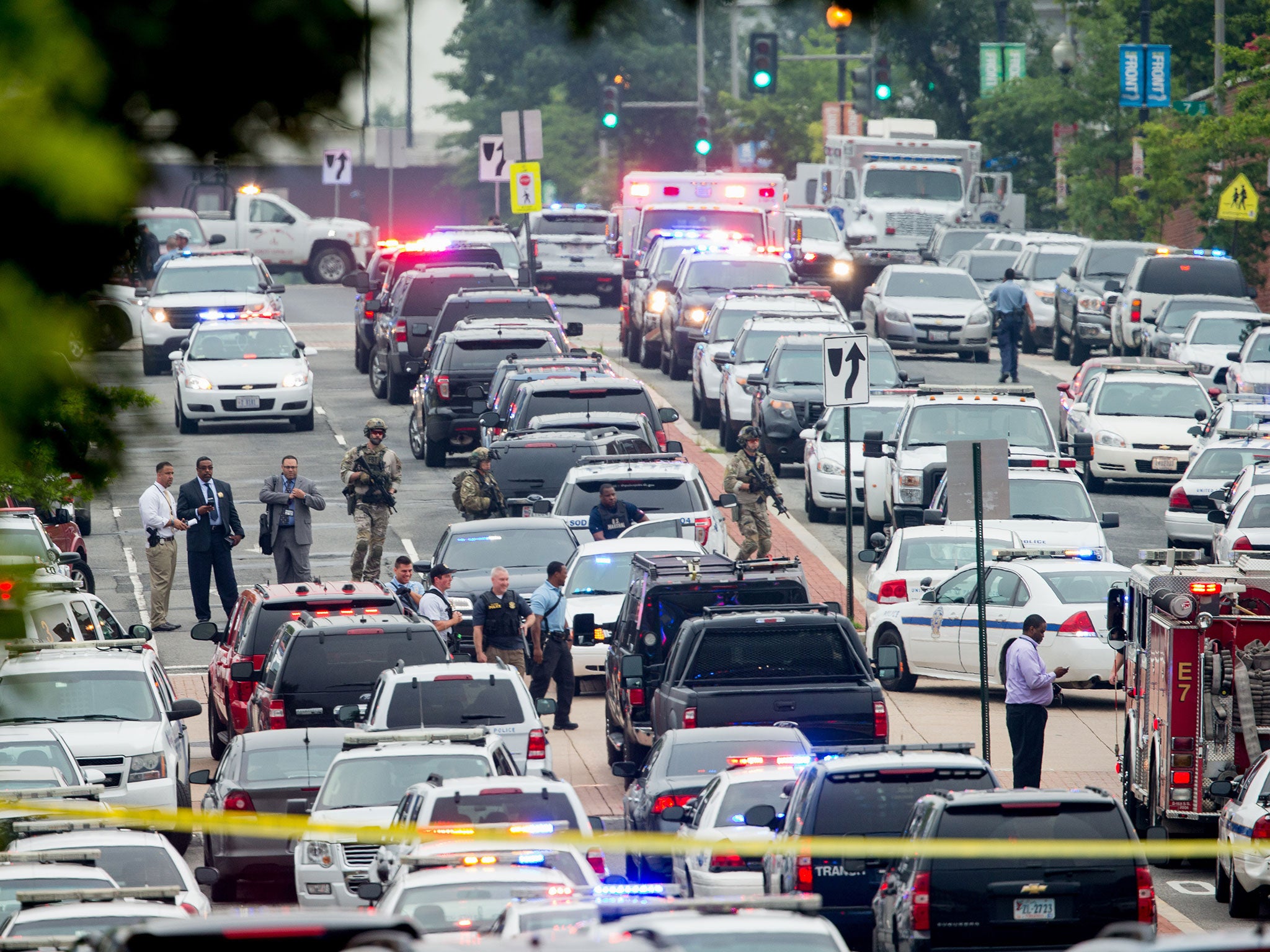 A large police presence gathers along M St. Southeast near the Navy Yard in Washington, after an official said shots were reported in a building on the Washington Navy yard campus