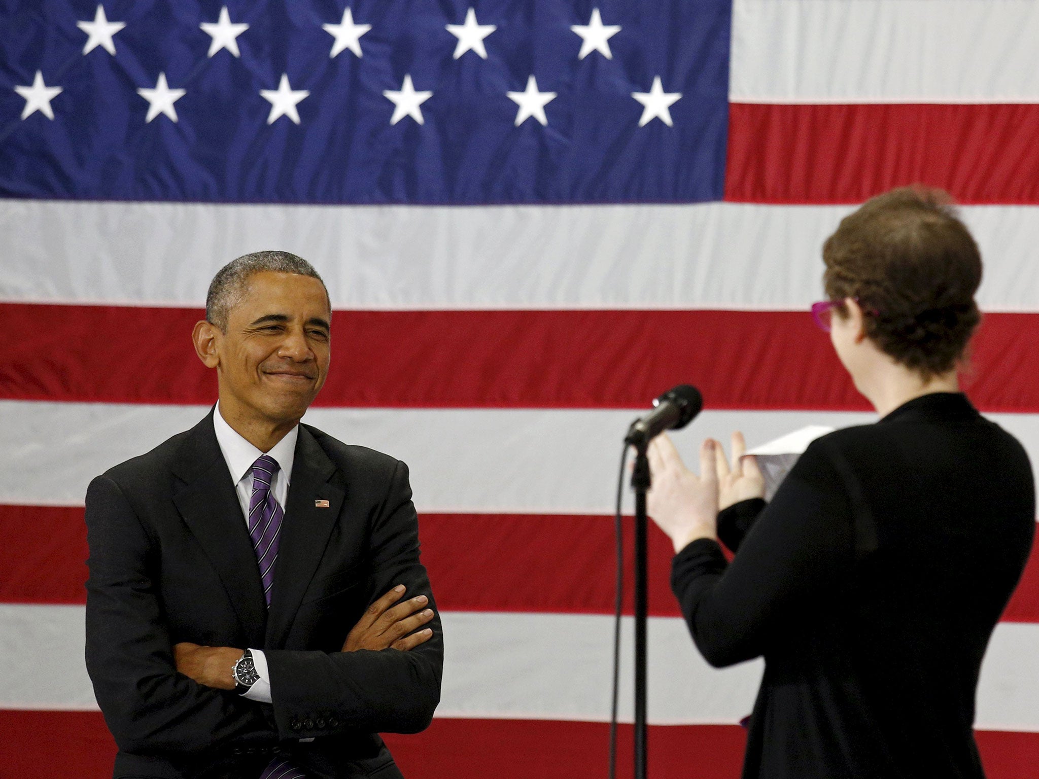 U.S. President Barack Obama receives applause from Kelly Bryant as she introduces him to speak about the Affordable Care Act during a visit to Taylor Stratton Elementary School in Nashville