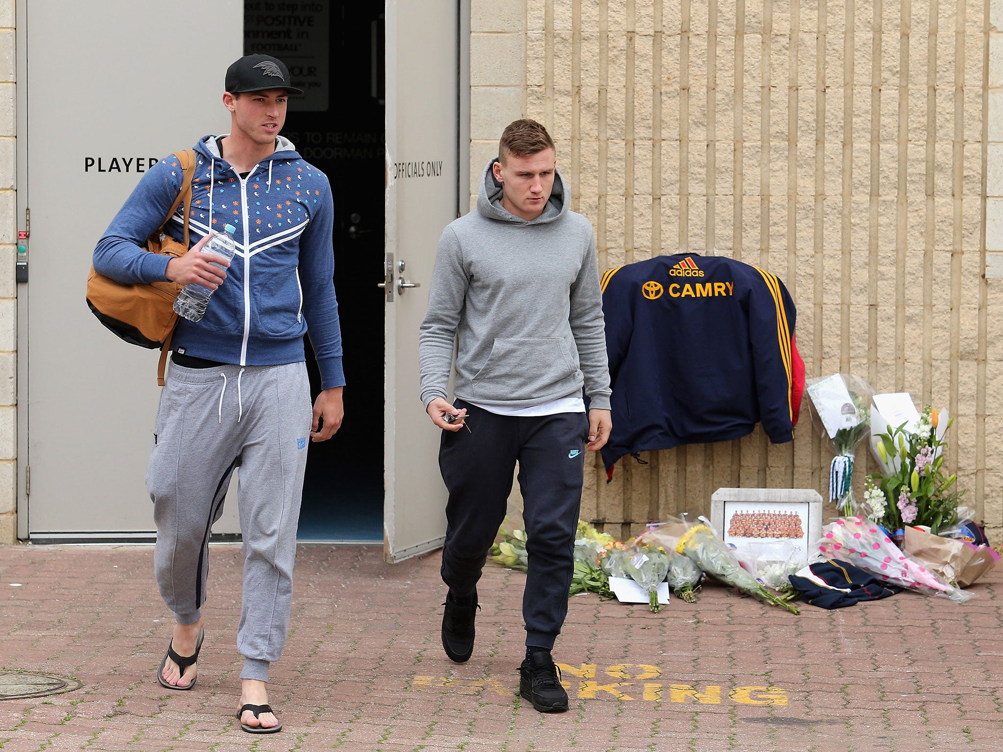 Adelaide players Daniel Talia and Rory Laird leave the Crows' club rooms