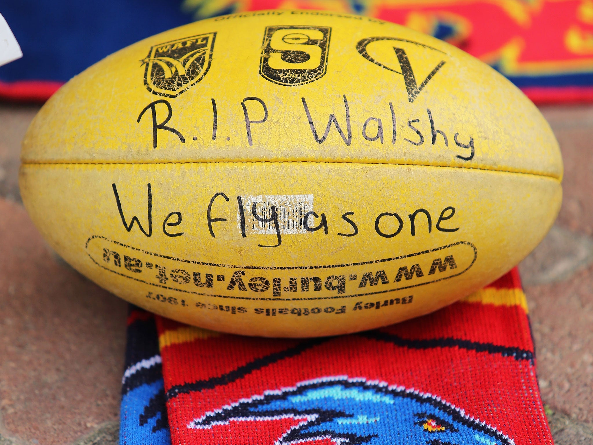 Tributes have been left to Walsh outside Adelaide's AAMI Stadium