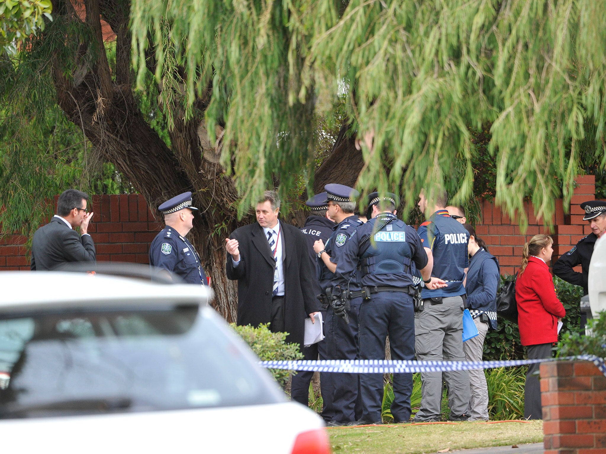Police are seen outside the home of Phil Walsh