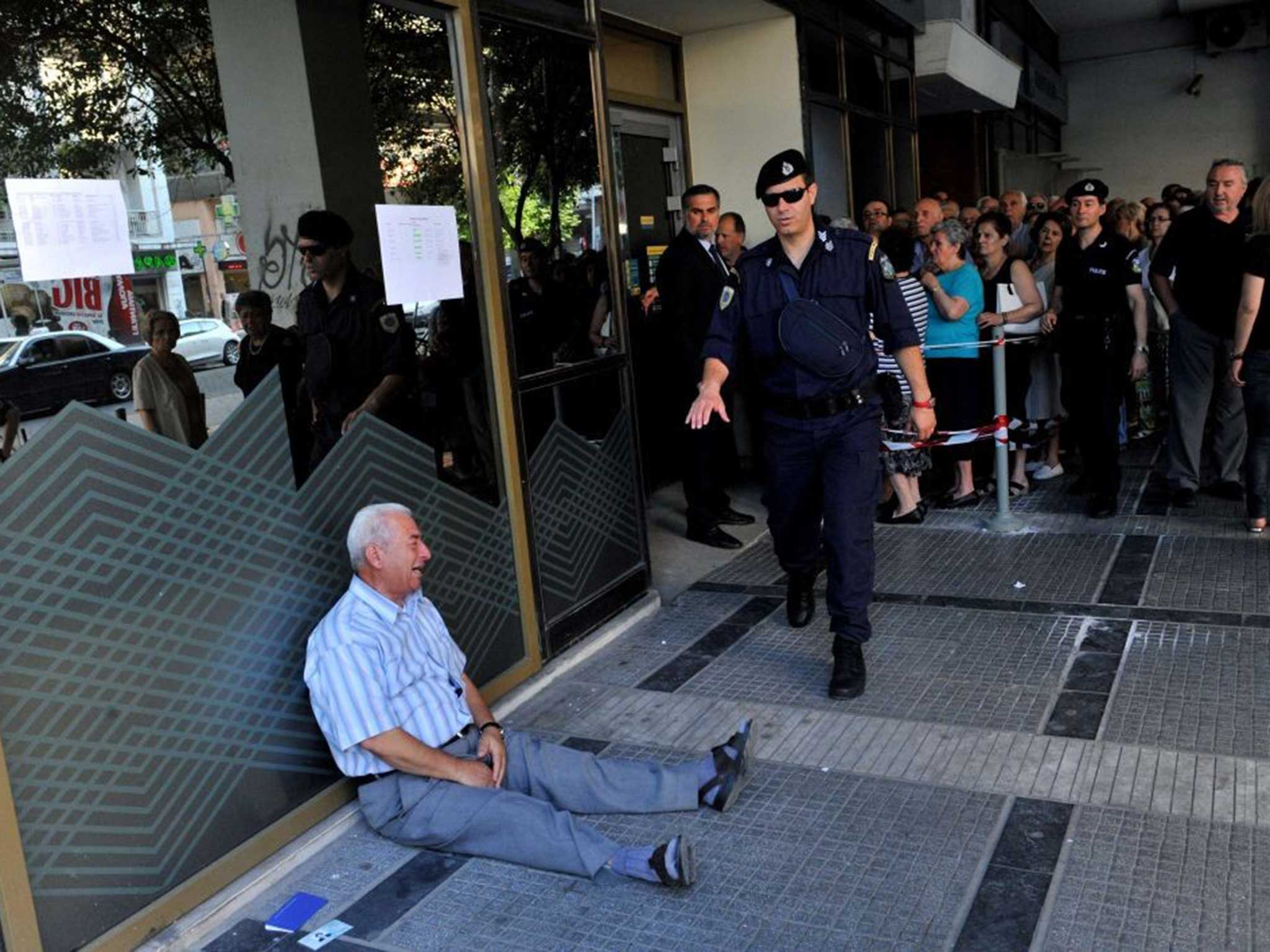 The unidentified man weeps outside the bank's branch