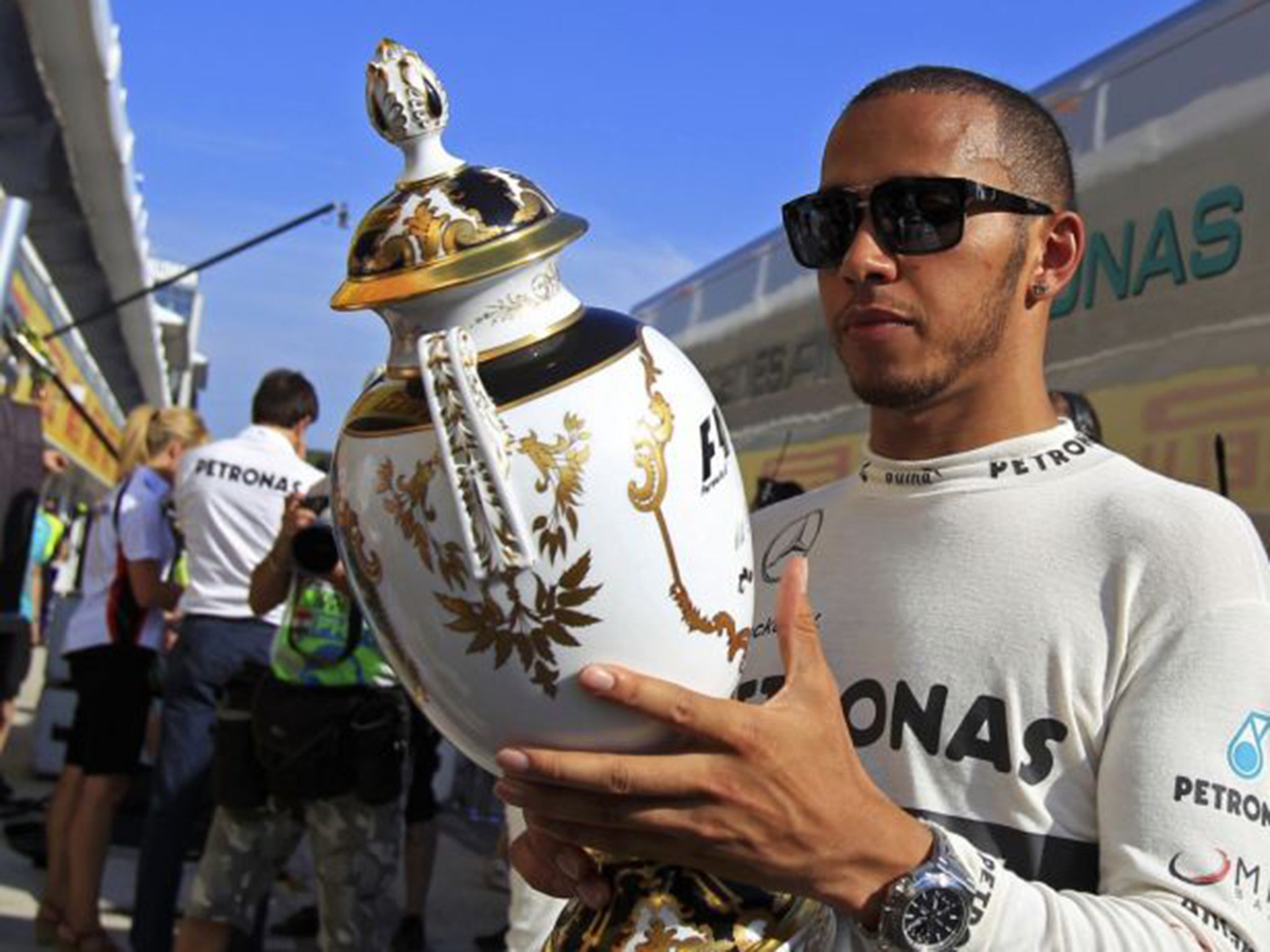 Not a gold cup in sight: British driver Lewis Hamilton with his trophy after his Grand Prix wins in Hungary