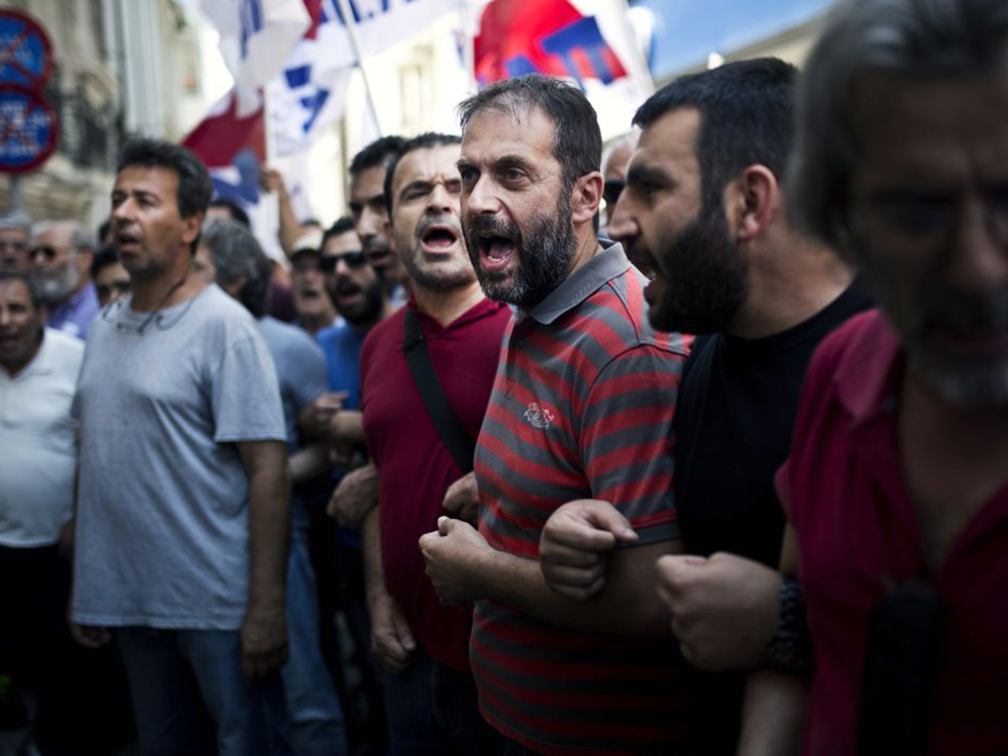 Greek Communist Party supporters outside the Federation of Greek Industries. They are campaigning for a "NO" vote