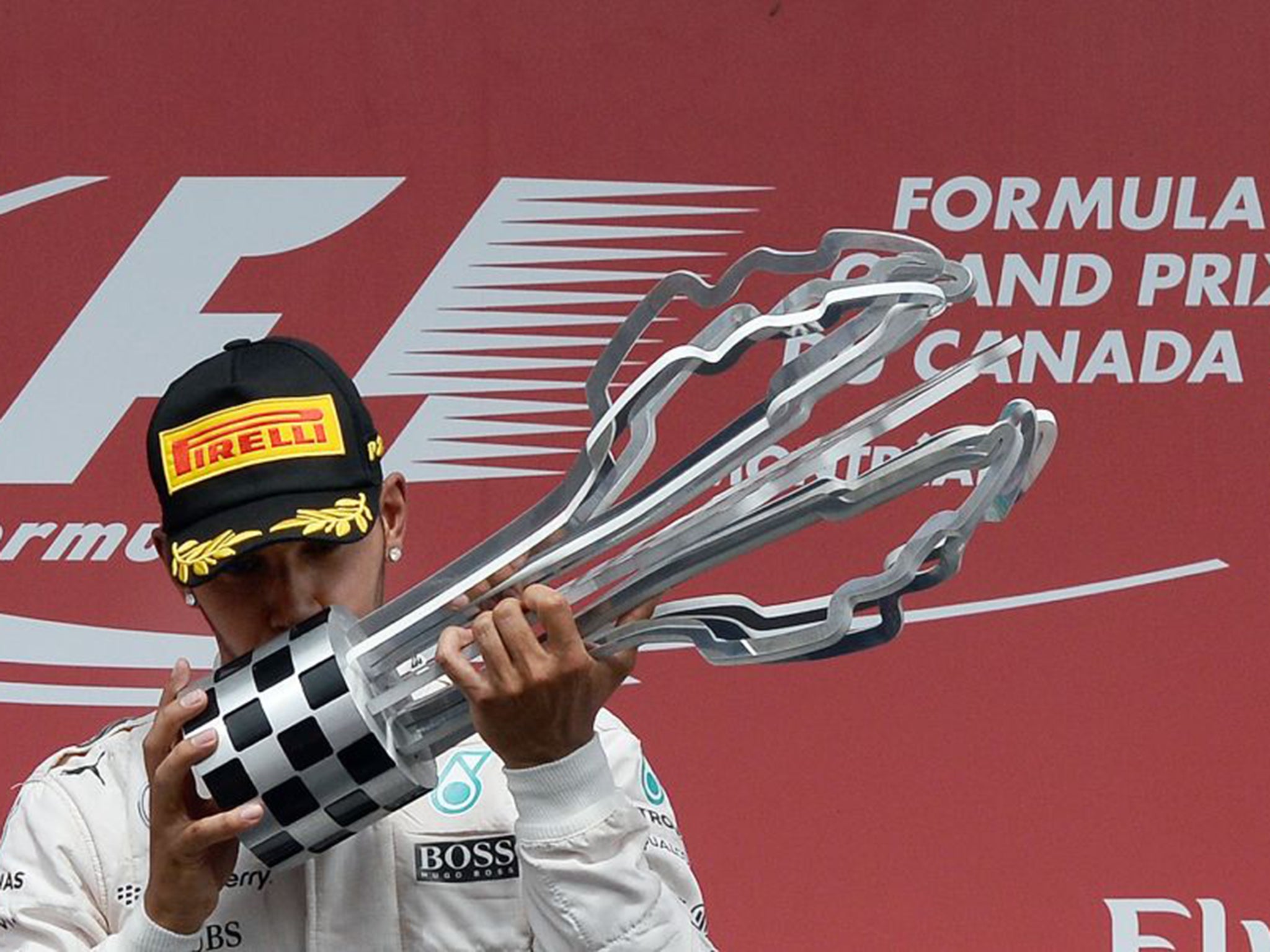 Lewis Hamilton kisses the trophy on the podium at the Circuit Gilles Villeneuve in Montreal earlier this month