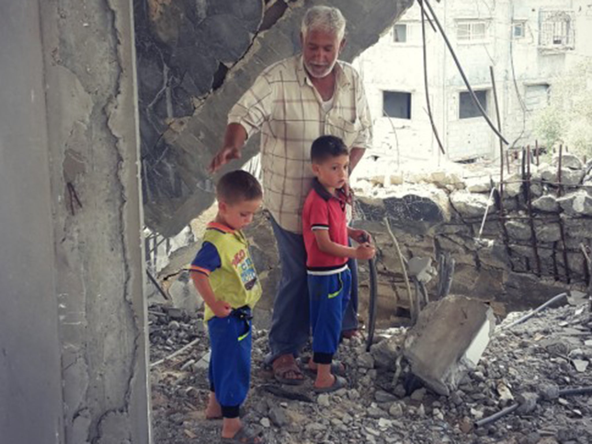 Rabah Abu Shanab, 47, in the ruins of his house in Shejaiya