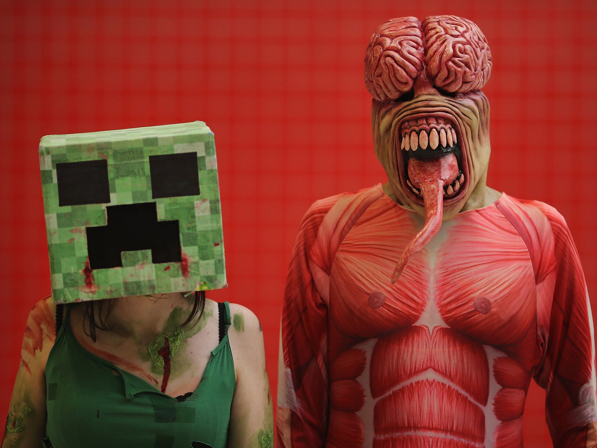 A Minecraft fan pose as a Creeper (left) from Sheffield as a Licker from Resident Evil (Image: Getty Images)