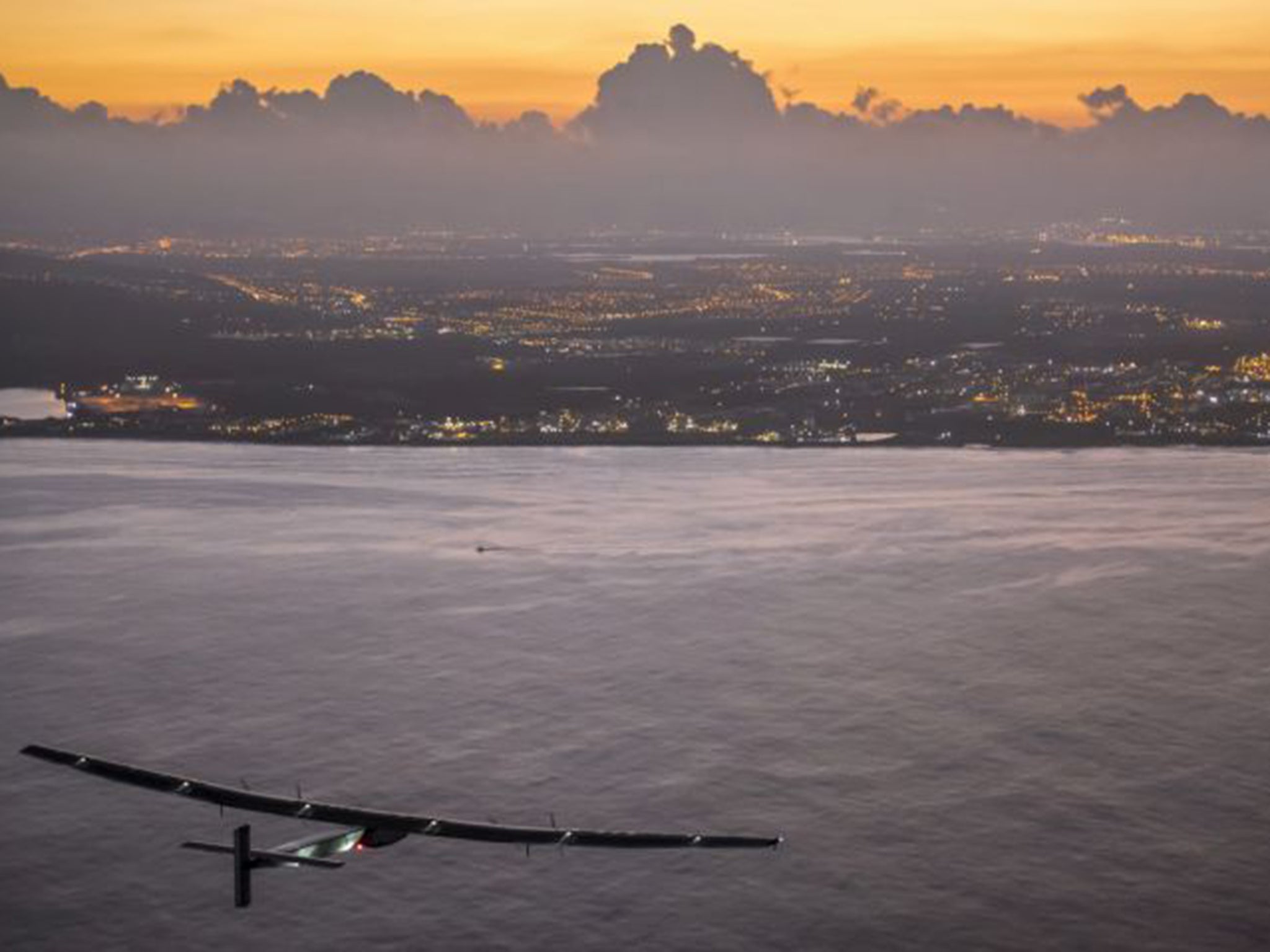 The Solar Impulse 2, powered by the sun's rays, approaches Kalaeloa Airport near Honolulu on Friday