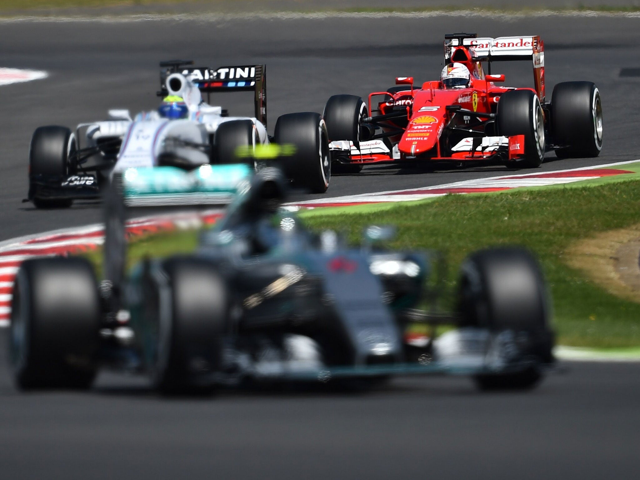 Rosberg flashes onto the Hangar Straight as Vettel tries to pass Massa