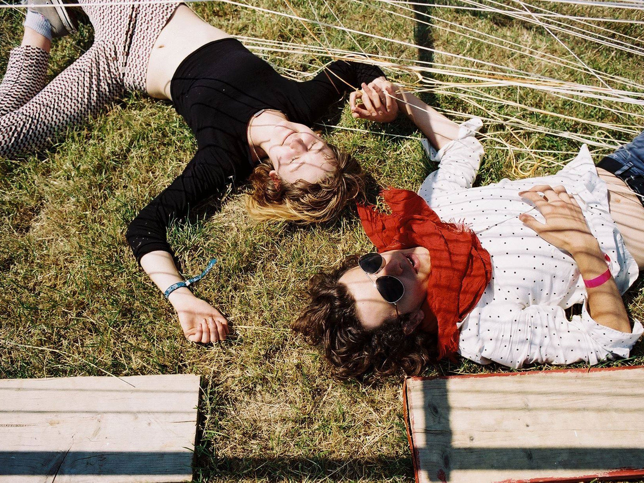 Festivalgoers lay under a sculpture