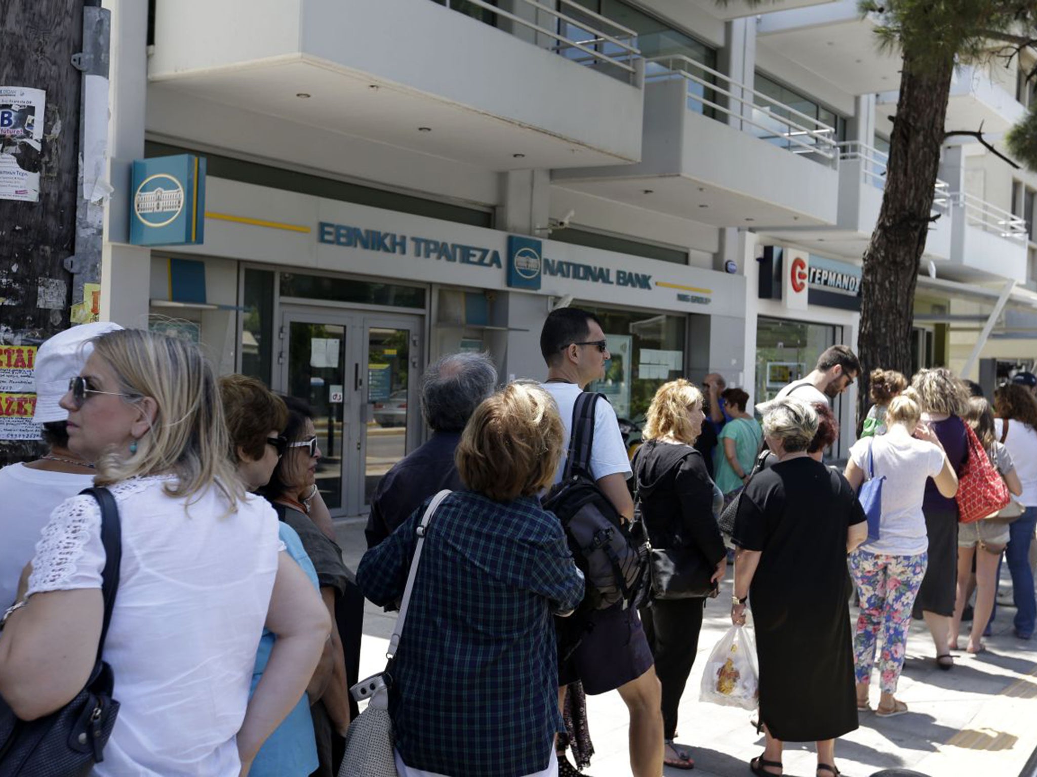 Queues form at ATMs. The daily allowance remains set at €60 [£43]