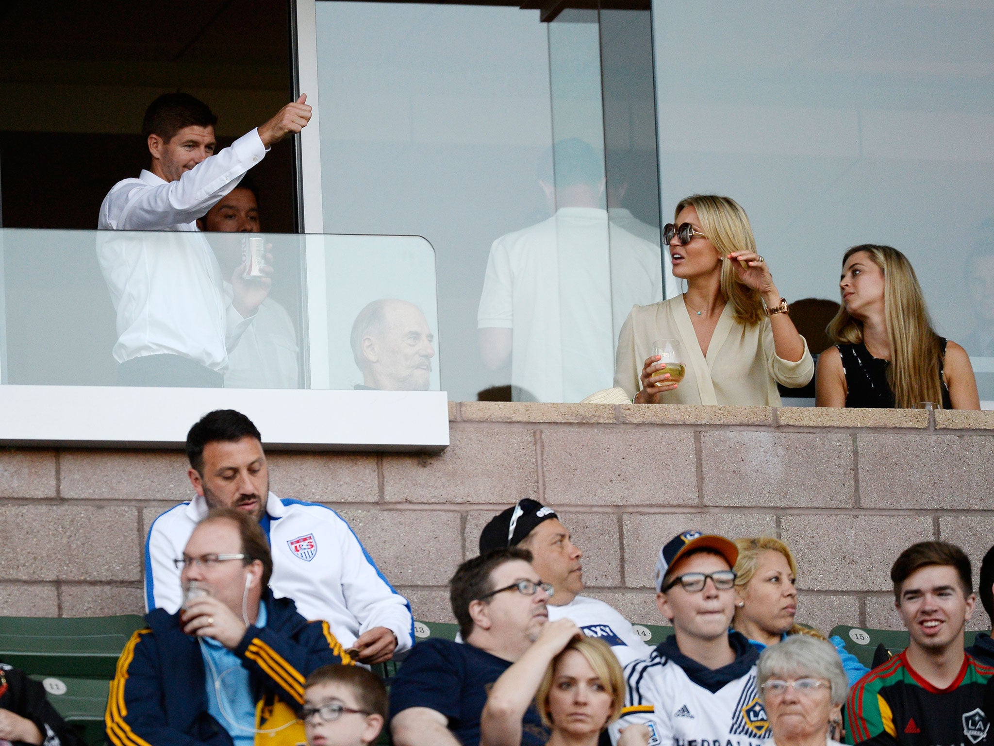 Gerrard hails the fans from the stands where his wife Alex sat