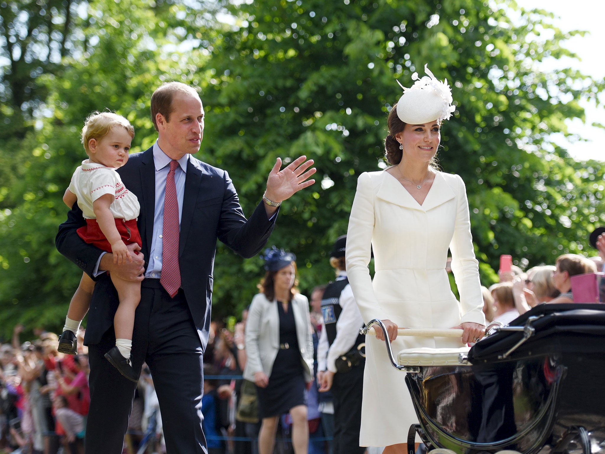 The Duke and Duchess of Cambridge walk past the crowds at the Church of St Mary Magdalene on the Sandringham Estate with their son Prince George and daughter Princess Charlotte, after her christening