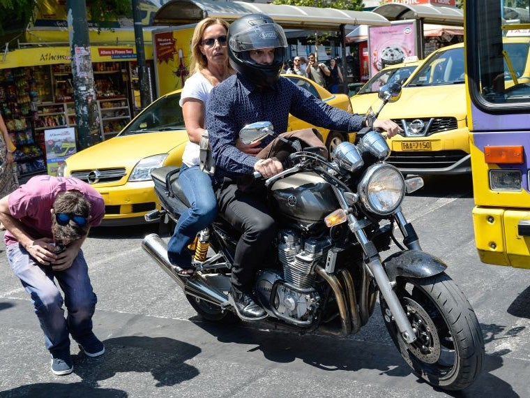 Greek finance minister Yanis Varoufakis leaves the finance ministry for good with his wife Danae Stratou