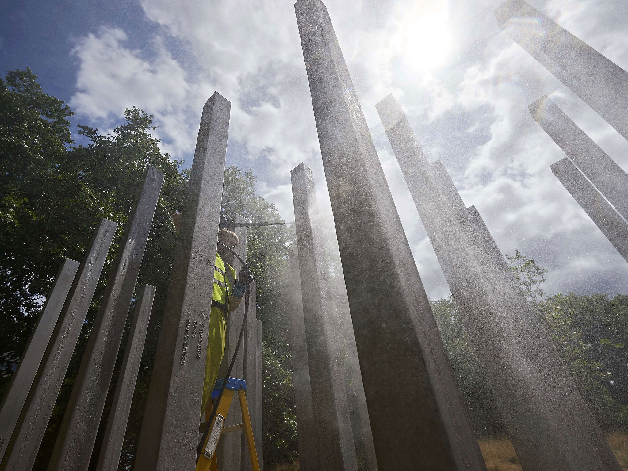A memorial dedicated to the 52 people that were killed during the 7/7 terror attacks in London is cleaned in London's Hyde Park