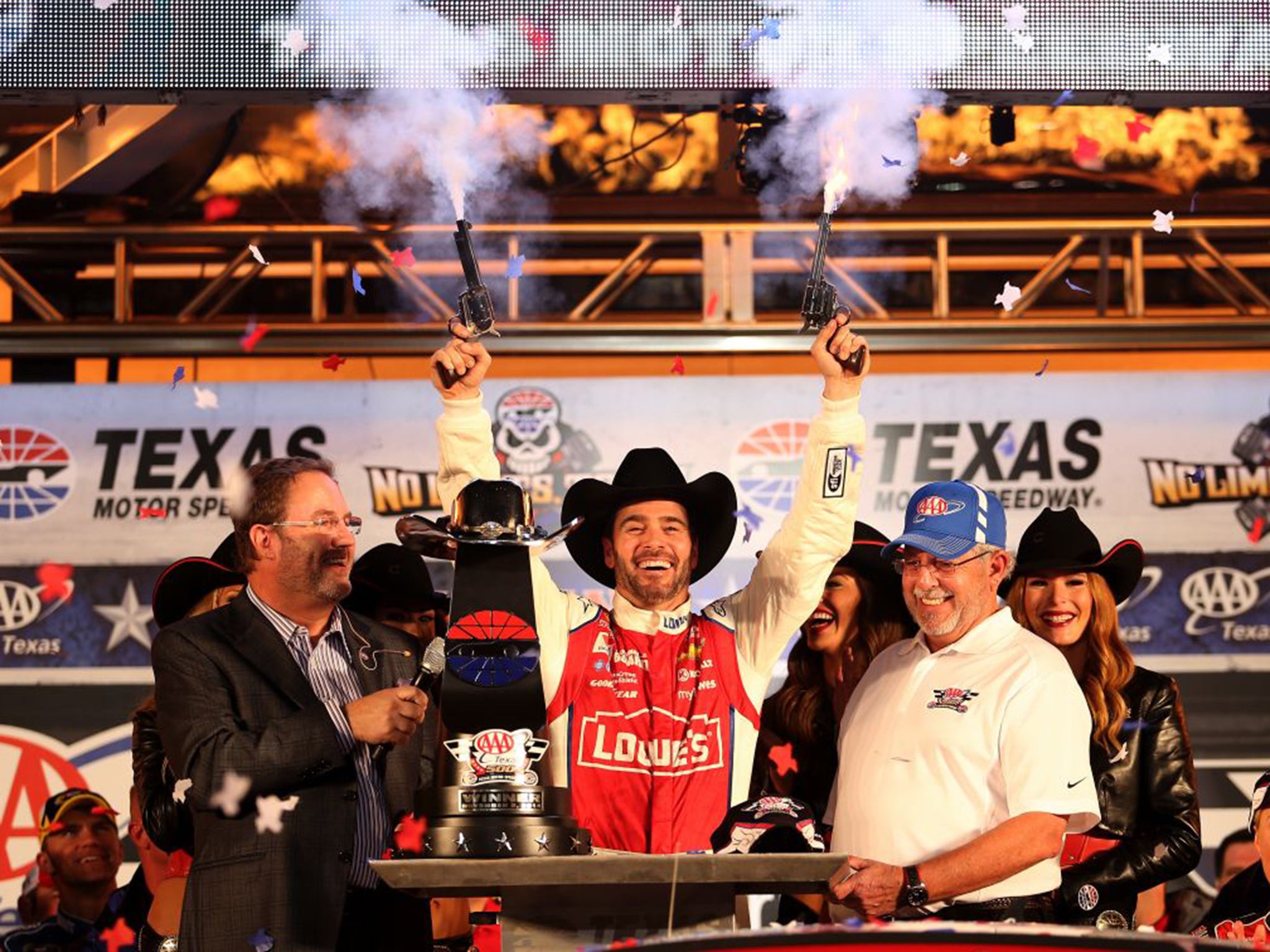 Jimmie Johnson, centre, celebrates with pistols winning the NASCAR Sprint Cup Series AAA Texas 500 last year