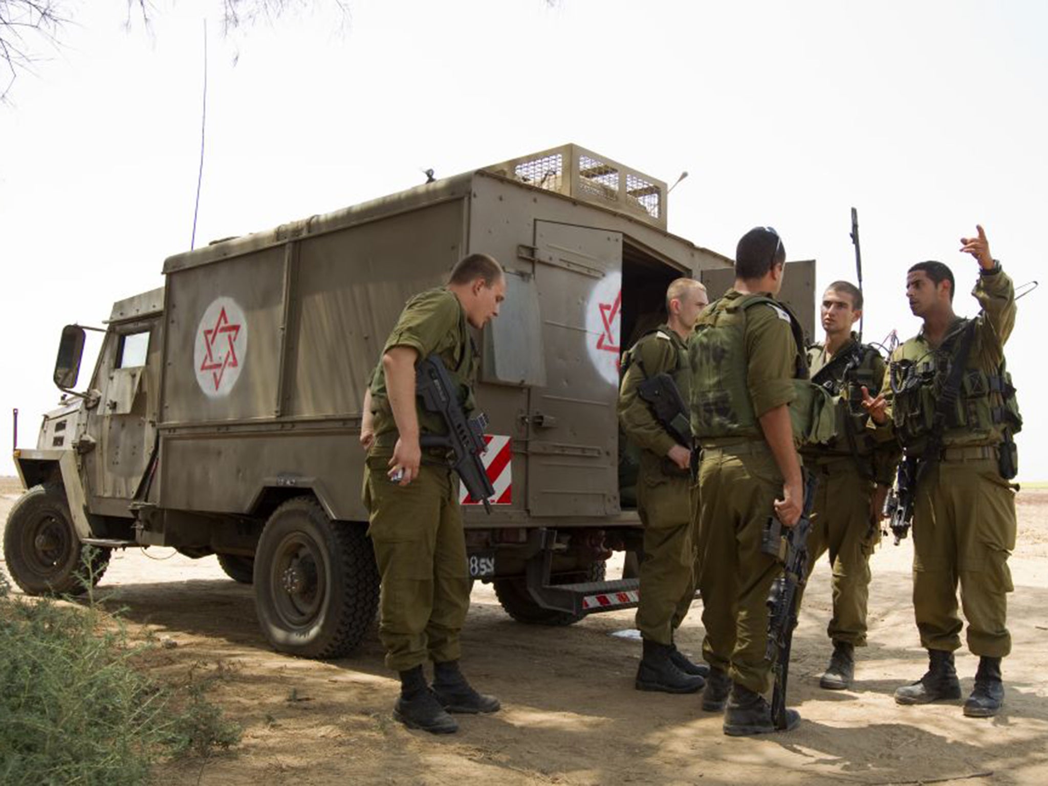 Israeli soldiers patrol the area close to the scene where two mortar bombs landed in the southern kibbutz of Nirim