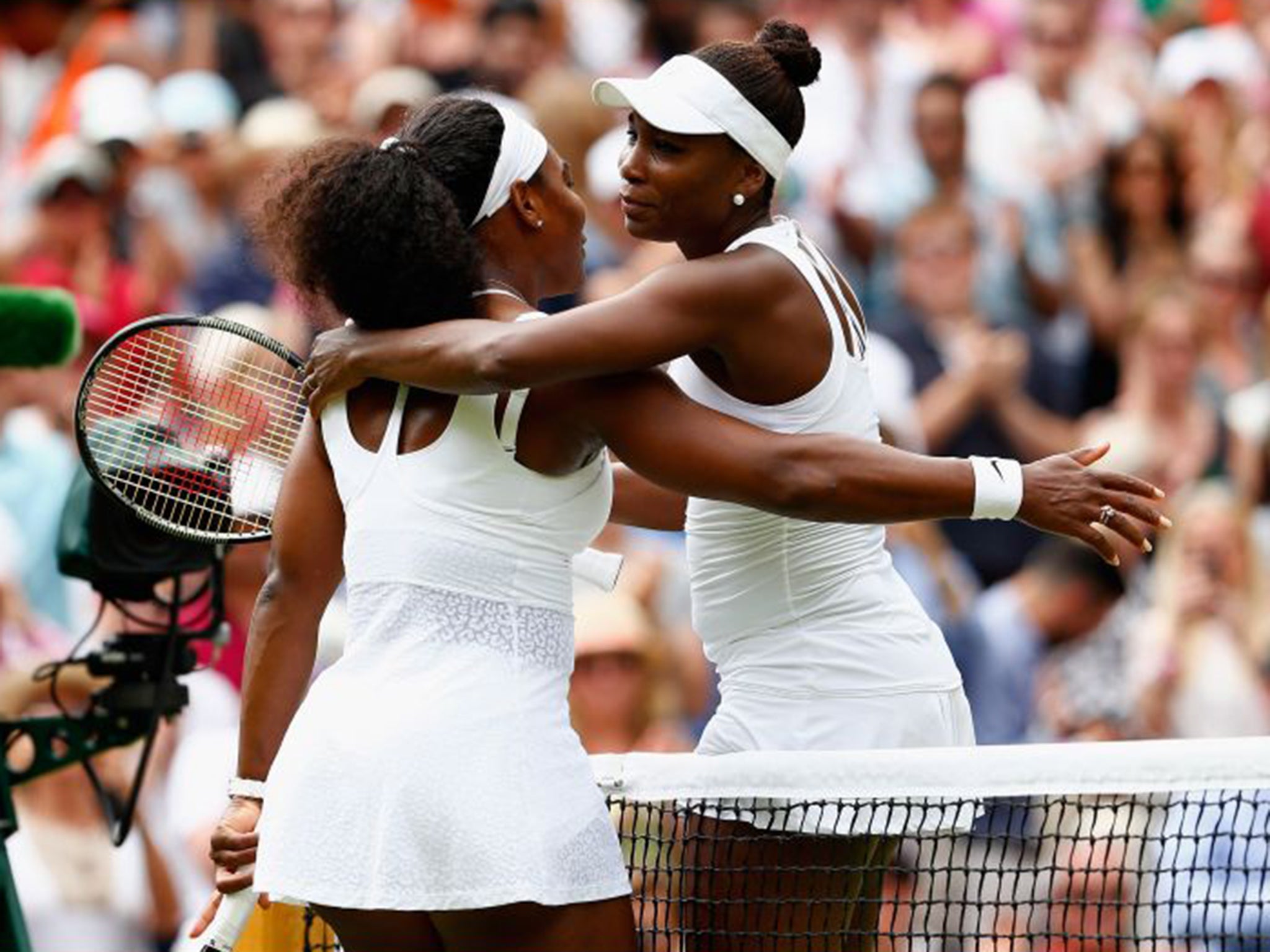 The Williams sisters embrace at the end of Monday’s match