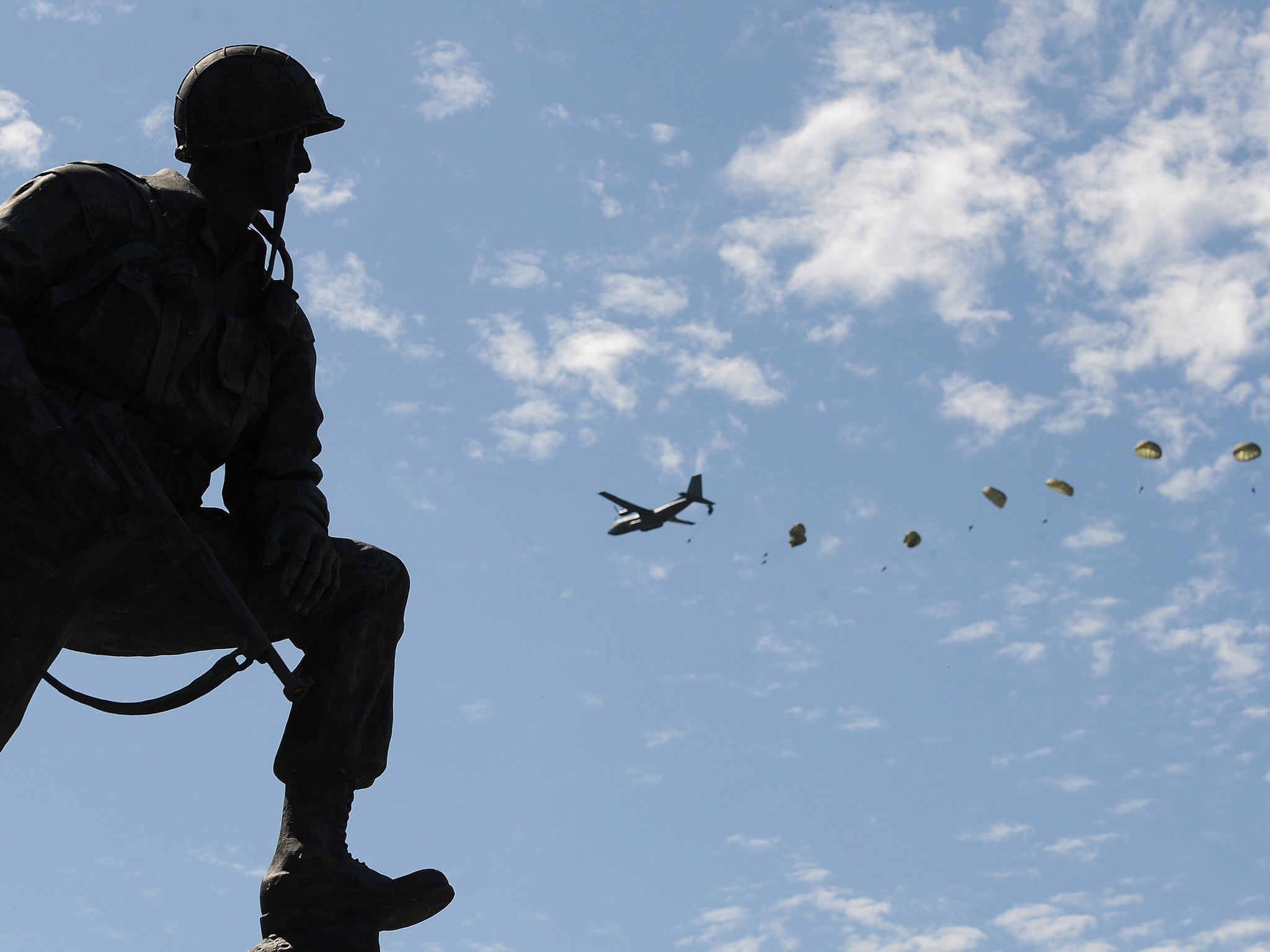 Paratroopers jump in Sainte-Mere-Eglise, northern France, during a D-Day commemoration to mark last year's 70th anniversary of the World War II Allied landings in Normandy (Getty)