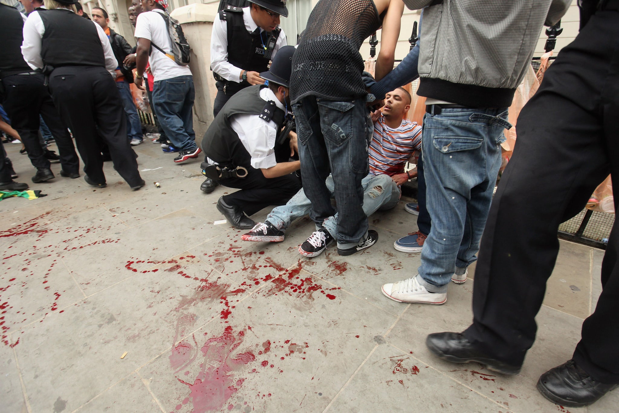 A man is given emergency medical attention after being stabbed at Notting Hill Carnival in 2011