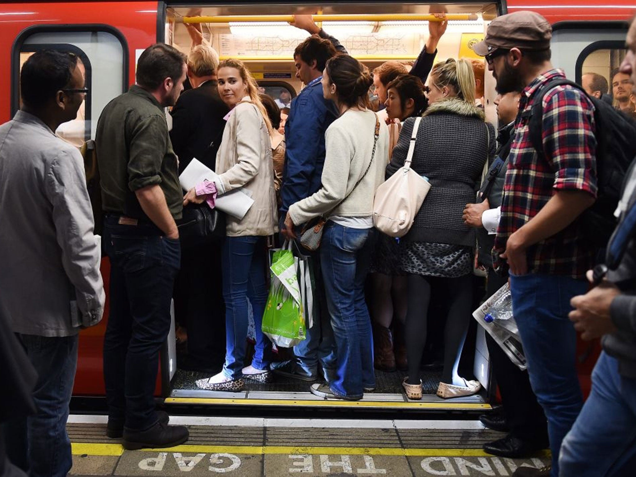 Commuters try to get onto a tube train at Westminster station in London, Britain, 08 July 2015.