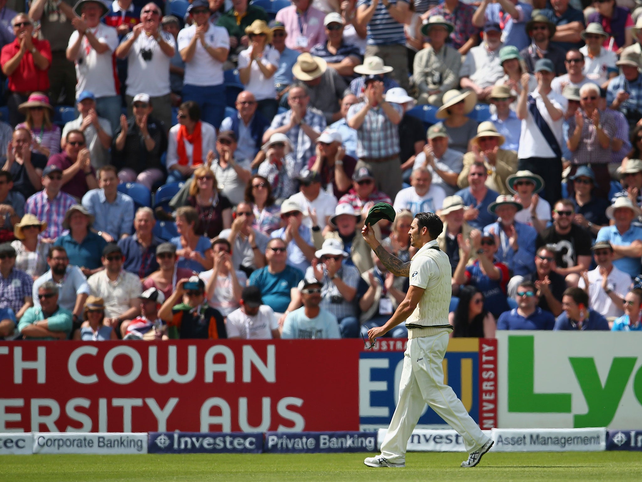 Johnson waves to the crowd as they applaud his rather unwanted century