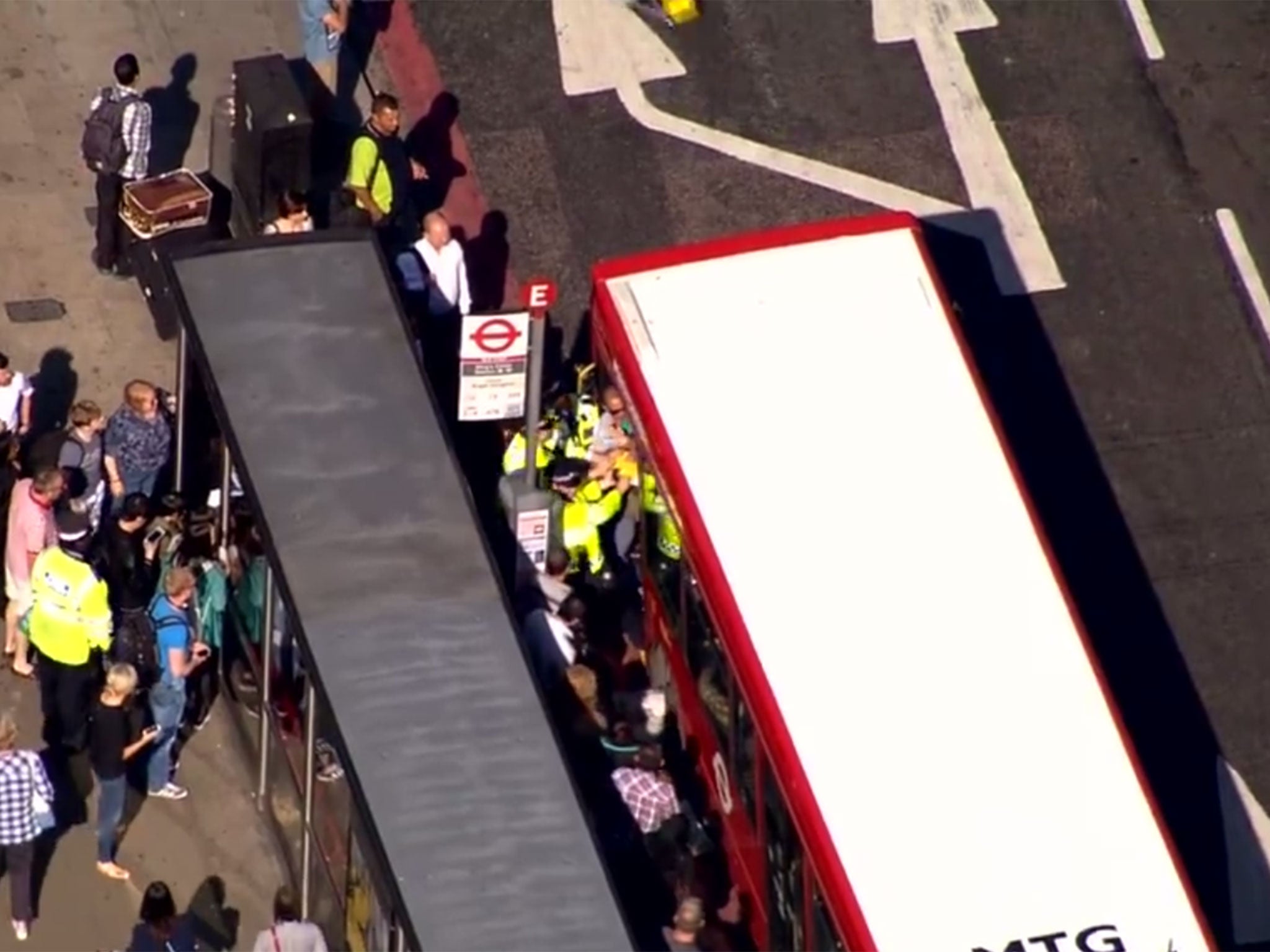 Police officers attend to a bus full of passengers