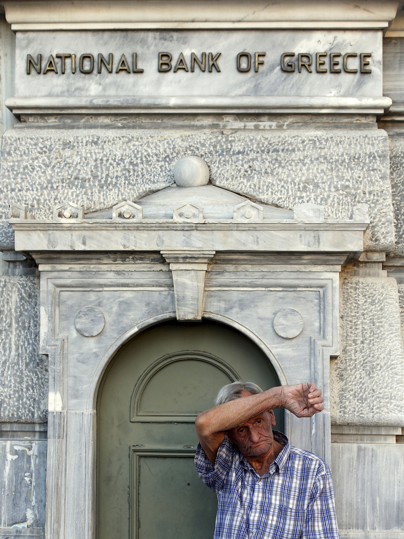 A pensioner waits anxiously to withdraw money